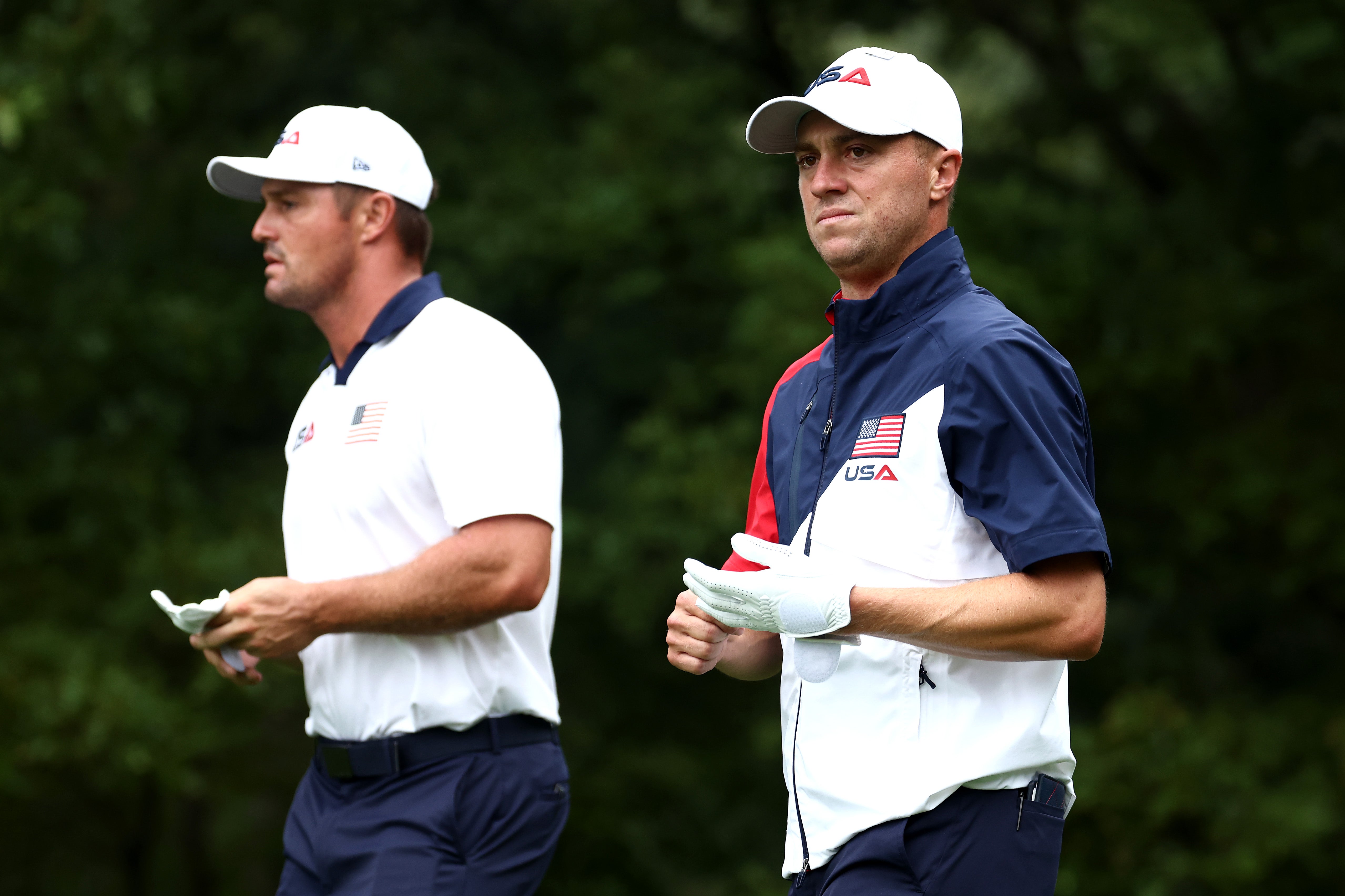 Justin Thomas of Team United States looks on while playing a practice round with teammate Bryson DeChambeau