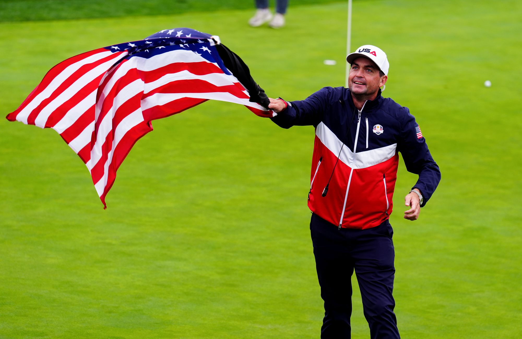 Captain Keegan Bradley waving the Flag of the United States on the 18th green at the Bethpage Black Course
