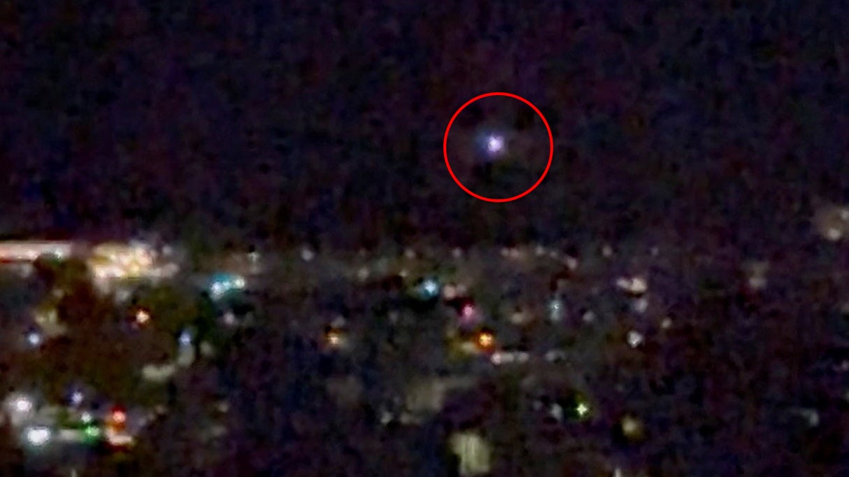 A light moves in the sky over Aalborg, amid reports of drone sightings that led to the city's airport to close