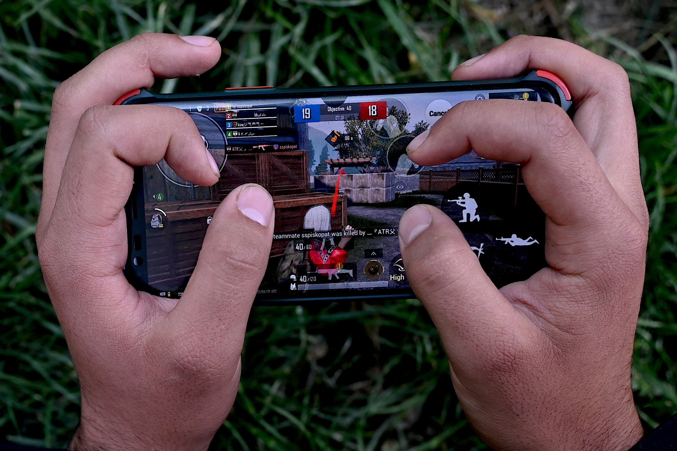 File. A boy playing PUBG on his mobile phone