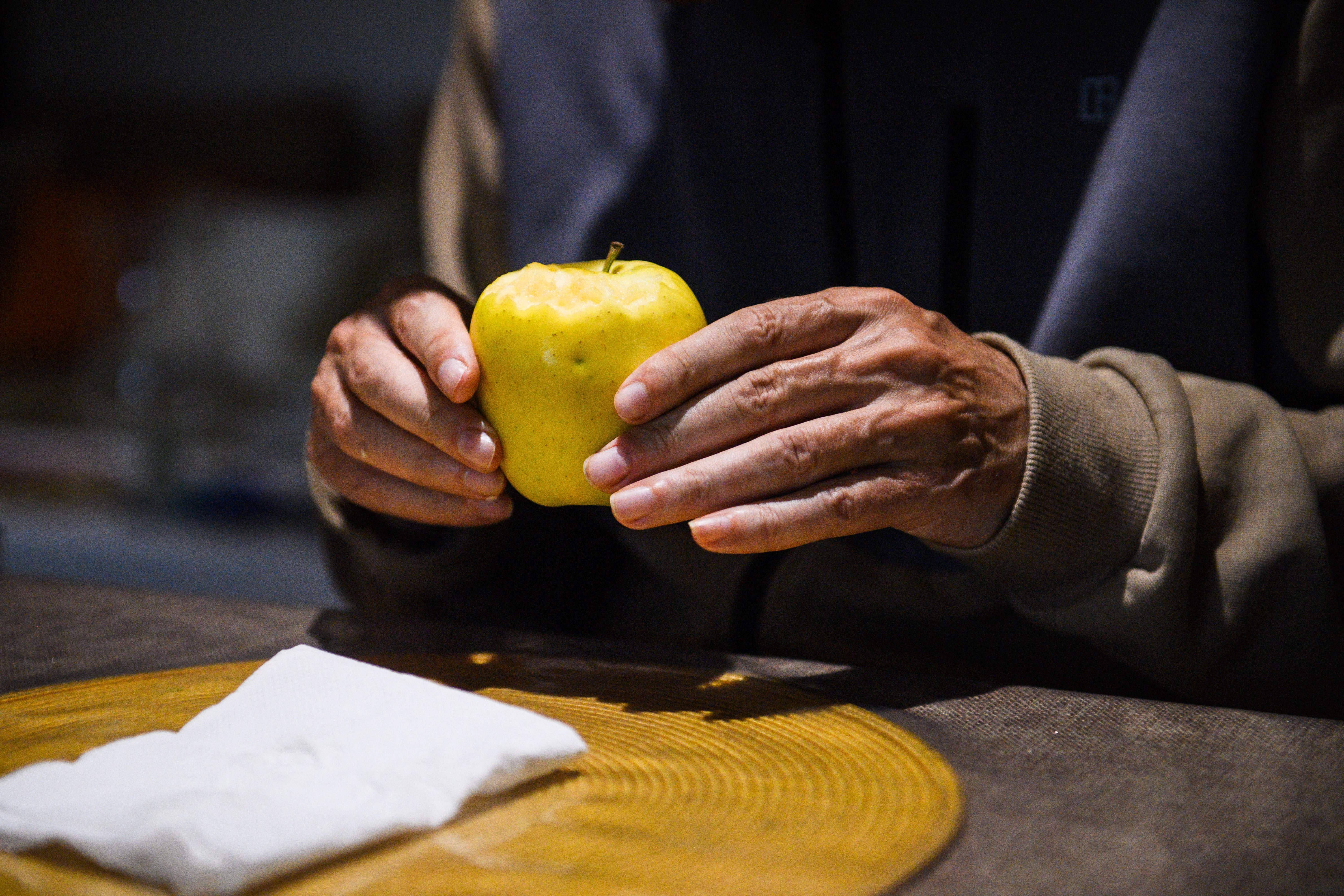Alzheimer's patient Jean-Marie holds an apple at "Les Papillons de Marcelle" house, in Arles, southeastern France