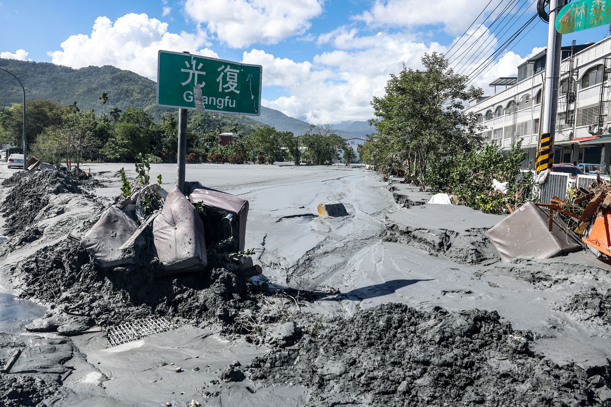 A road sign for Guangfu is stuck in the mud after a barrier lake burst in Hualien on September 25, 2025, following torrential rain when Super Typhoon Ragasa skirted Taiwan. Ragasa's passage in Taiwan killed at least 14 and injured 46 when a decades-old barrier lake burst in eastern Hualien county, according to regional officials