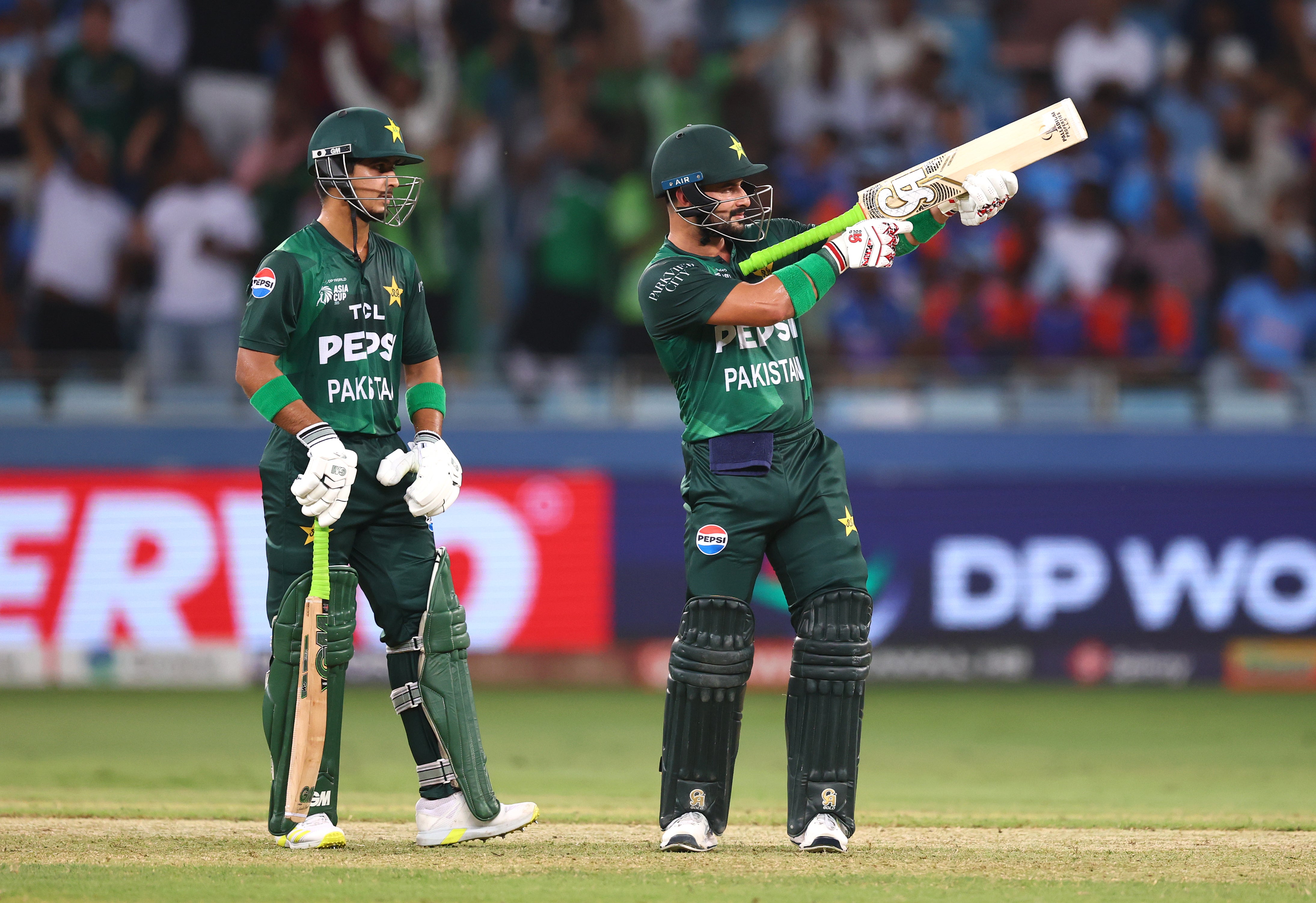 Sahibzada Farhan (R) of Pakistan celebrates after reaching his half-century during the Asia Cup match between India and Pakistan at Dubai International Stadium on 21 September 2025 in Dubai, United Arab Emirates