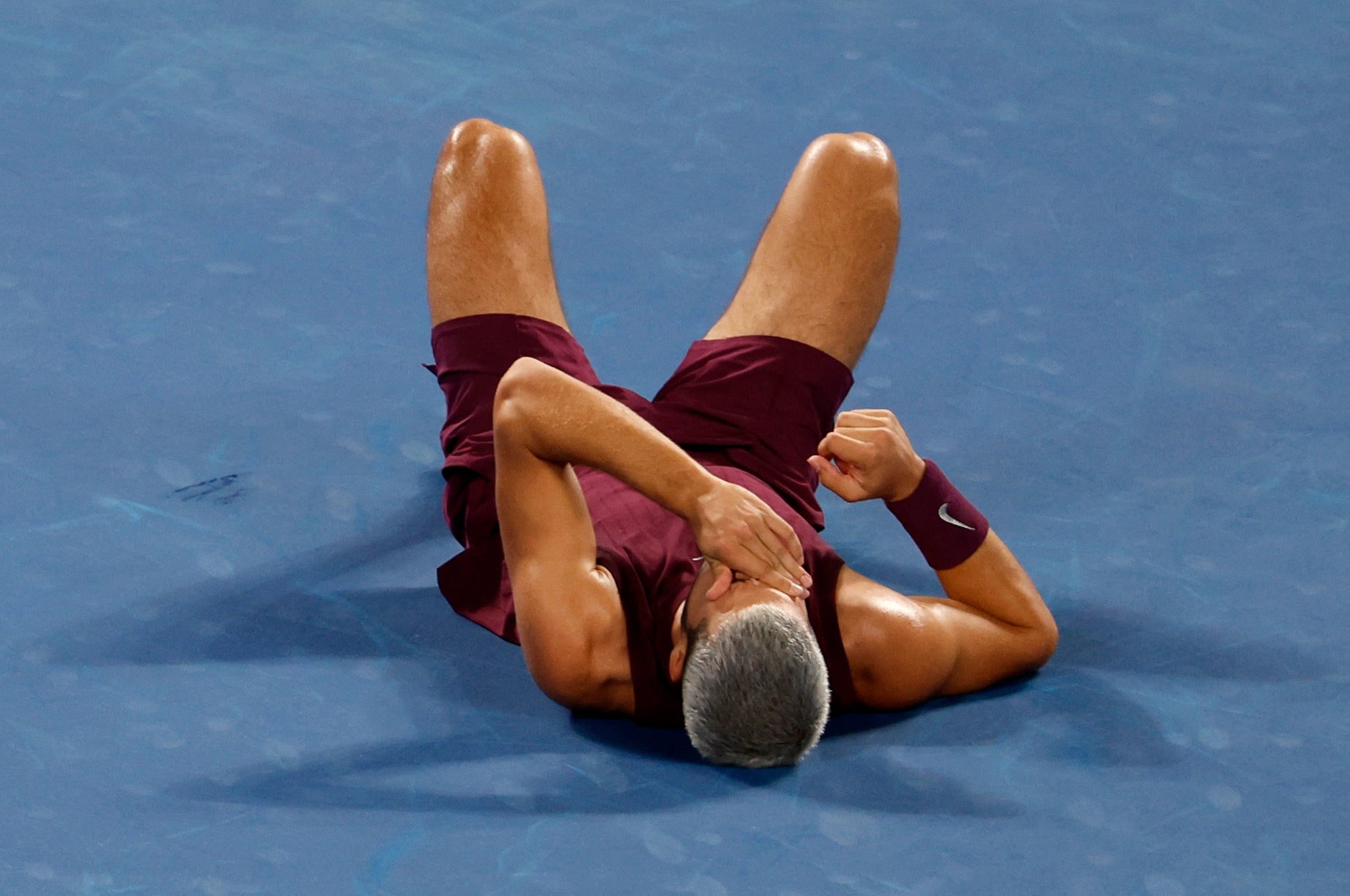 Alcaraz fell to his back after appearing to hurt his foot