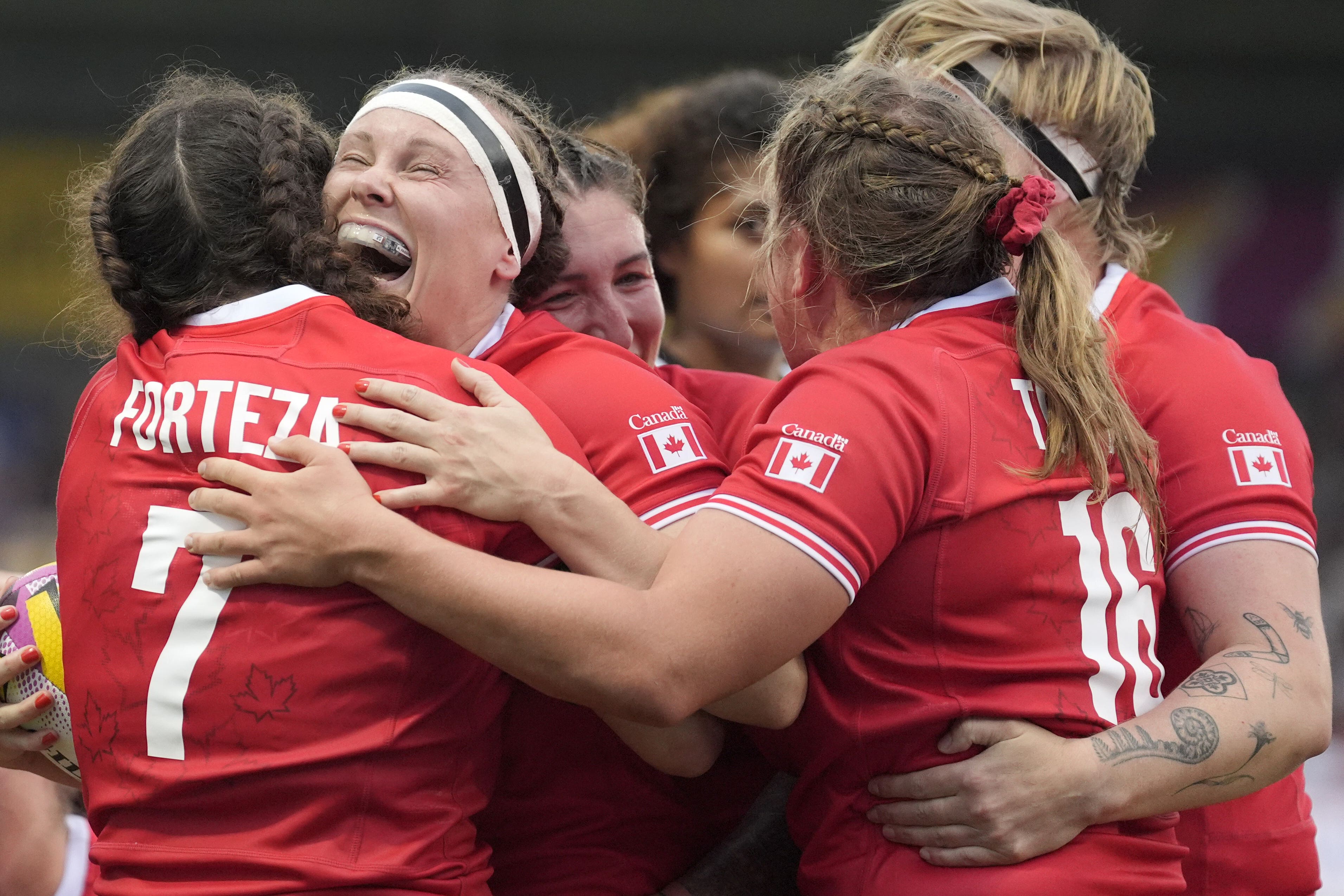 Karen Paquin, second left, celebrates scoring in Canada’s pool-stage win over Fiji (Danny Lawson/PA)