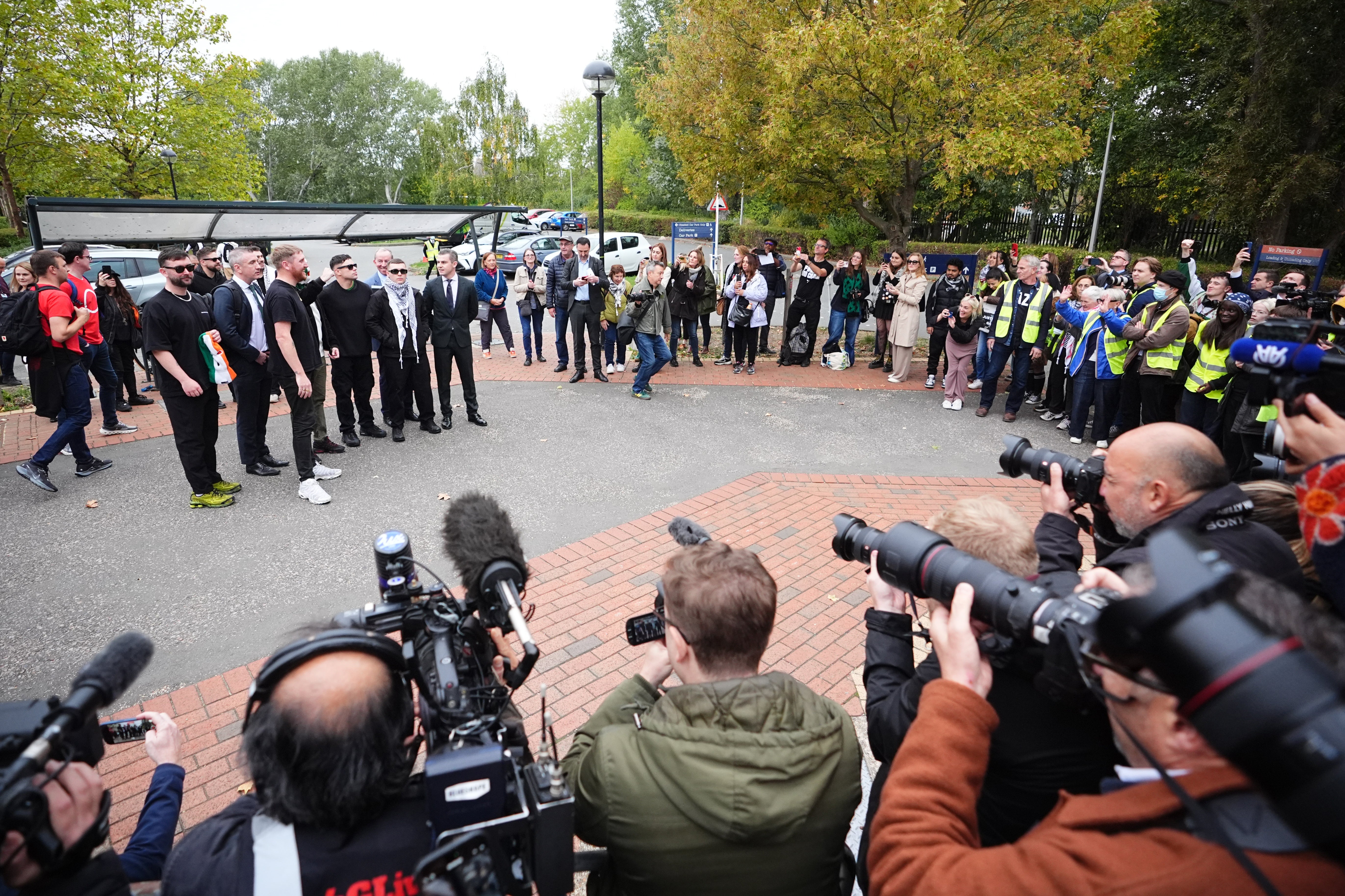 Kneecap’s Liam Óg Ó hAnnaidh (second right, in keffiyeh), with (second left to right) band manager Daniel Lambert, JJ Ó Dochartaigh, Naoise Ó Cairealláin and lawyer Darragh Mackin, posing for a photo outside Woolwich Crown Court, London