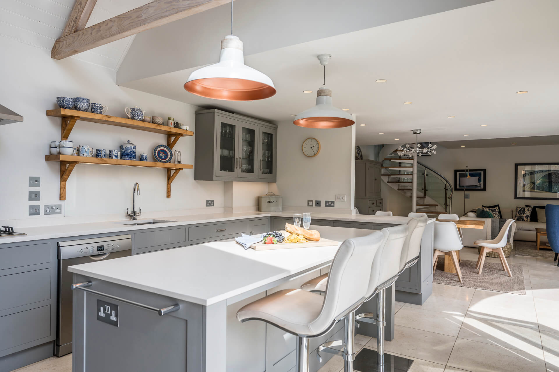 A white, grey and stone open-plan living area is found at Cloudbreak