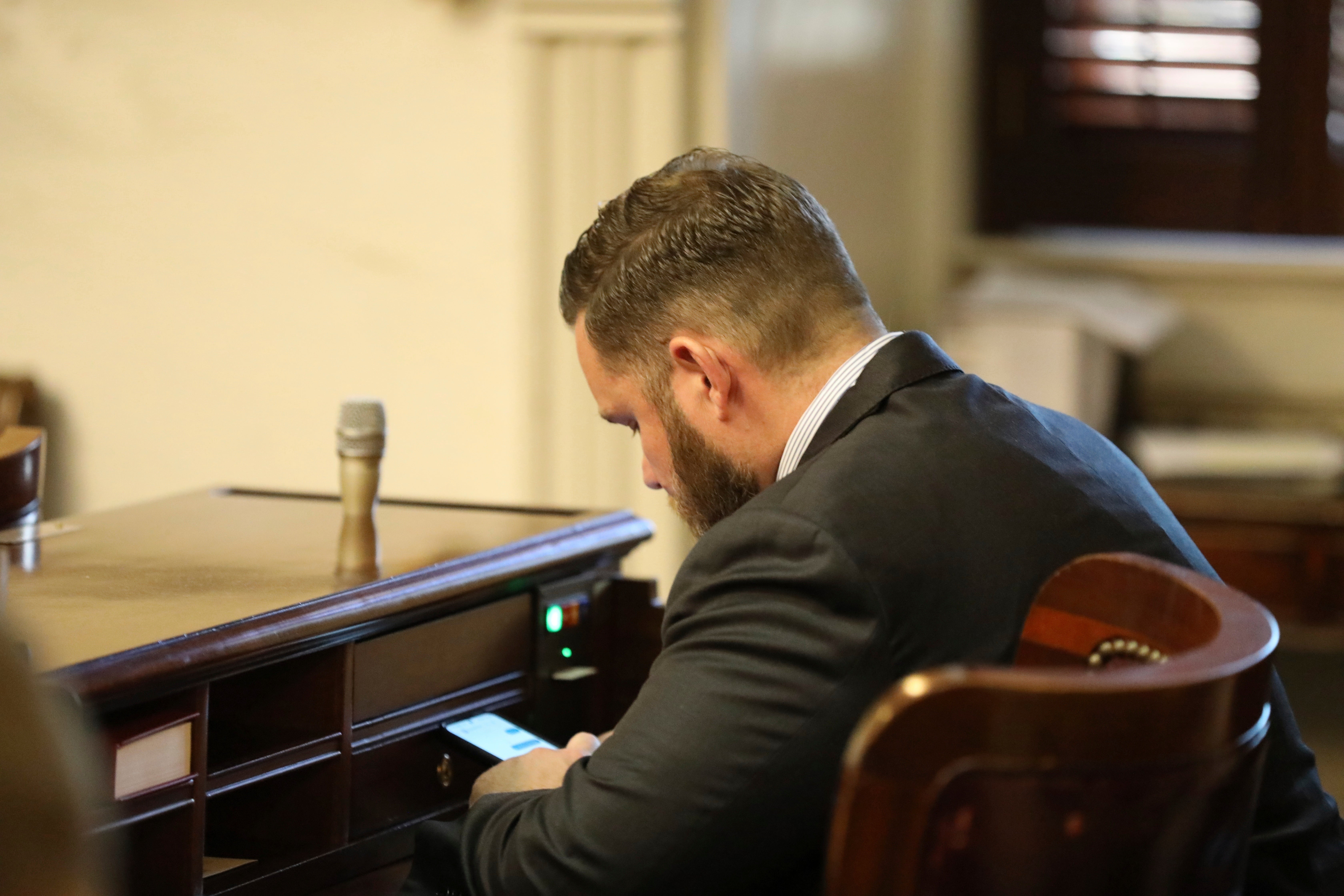Republican South Carolina Rep. R.J. May of Lexington sits at his new desk during the organizational session for the House on Tuesday, Dec. 3, 2024, in Columbia, S.C. (AP Photo/Jeffrey Collins, file)