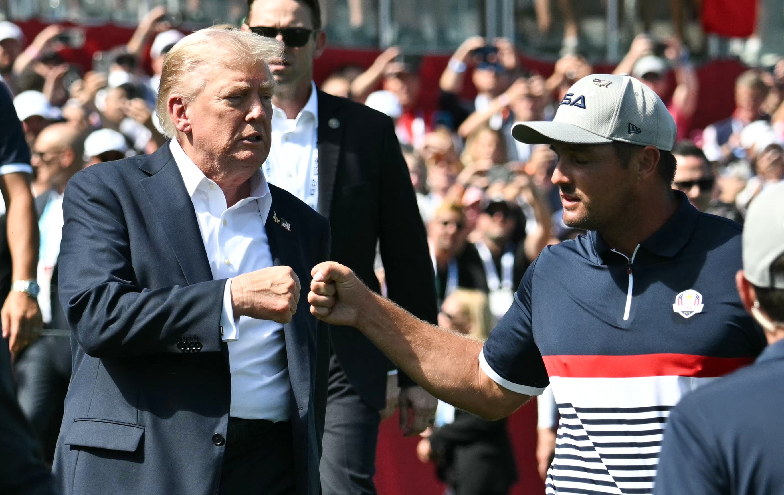 President Donald Trump, left, fist-bumps United States' Bryson DeChambeau