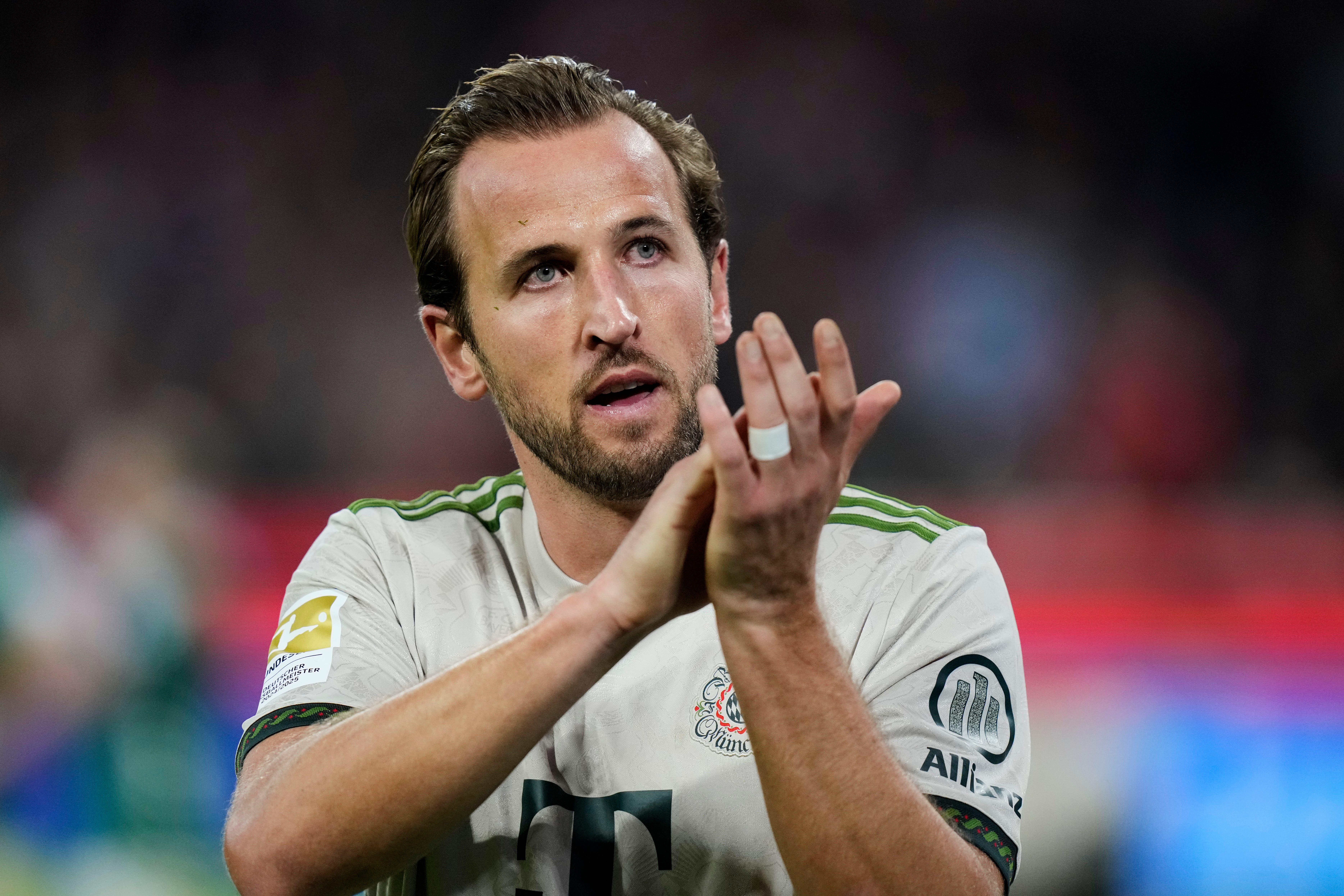 Harry Kane applauds after hitting another landmark (Matthias Schrader/AP)