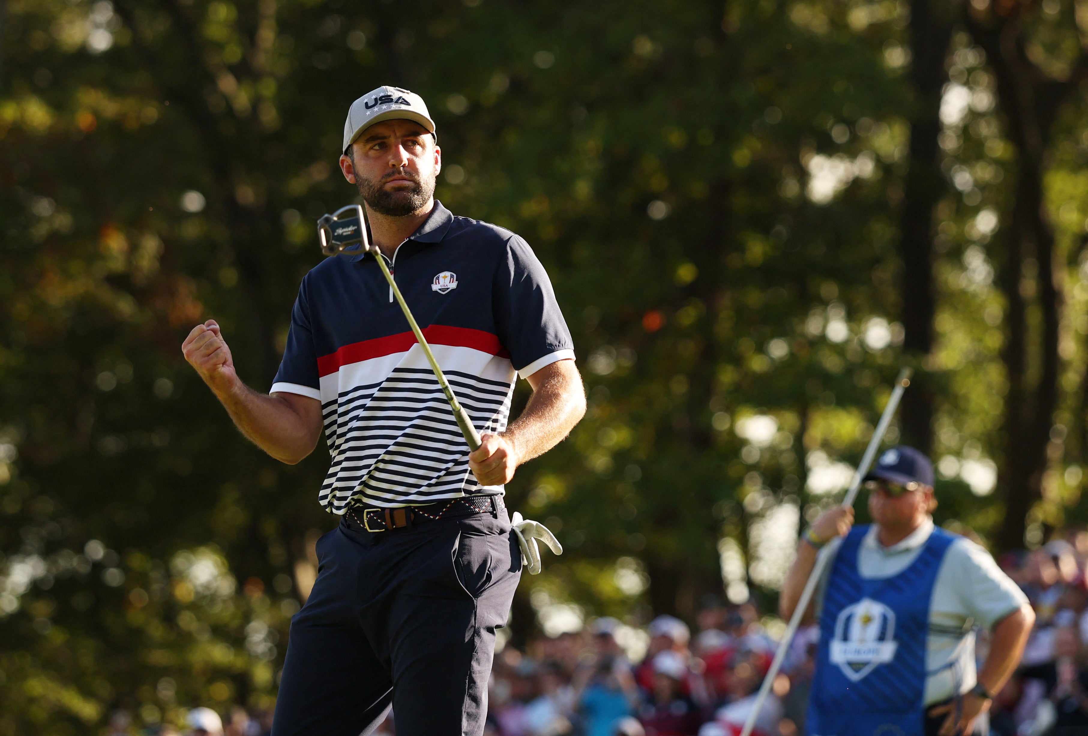 Team USA's Scottie Scheffler celebrates after holing his putt on the 15th hole