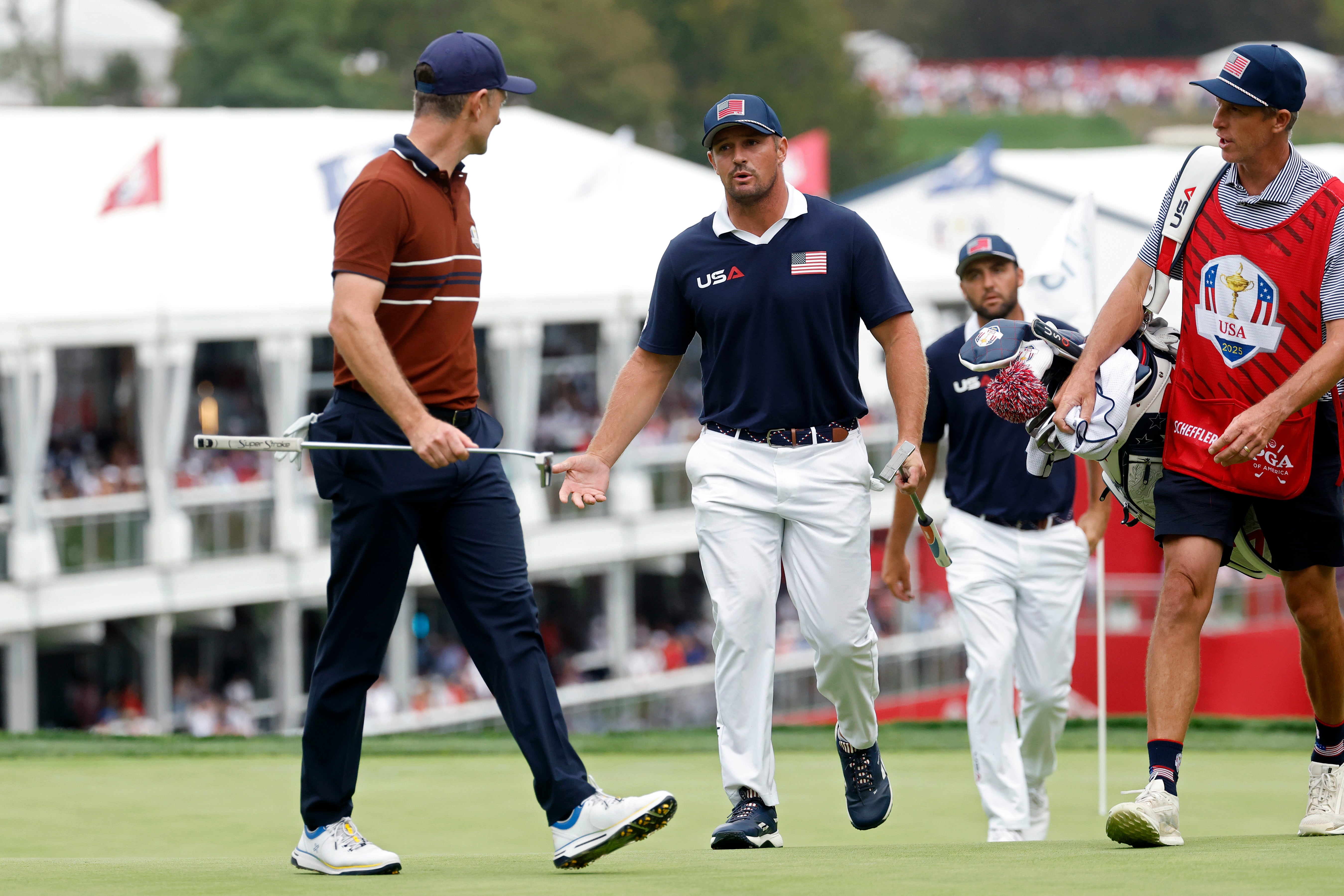 Justin Rose of Team Europe and Bryson DeChambeau of Team United States exchange words