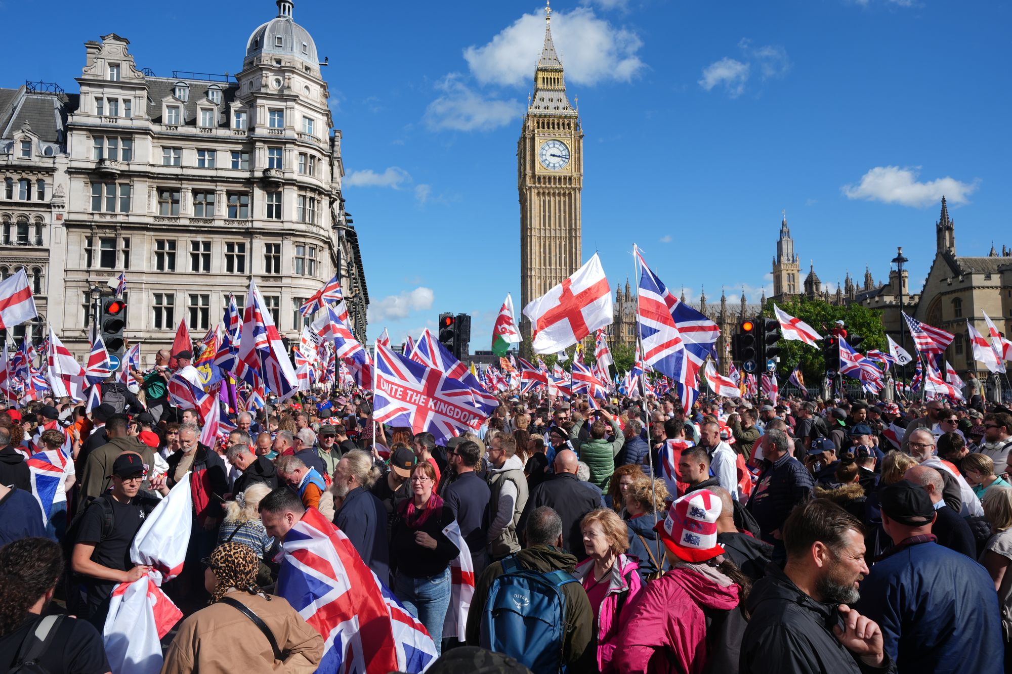 People taking part in a Tommy Robinson-led Unite the Kingdom march and rally in Parliament Square, central London on 13 September