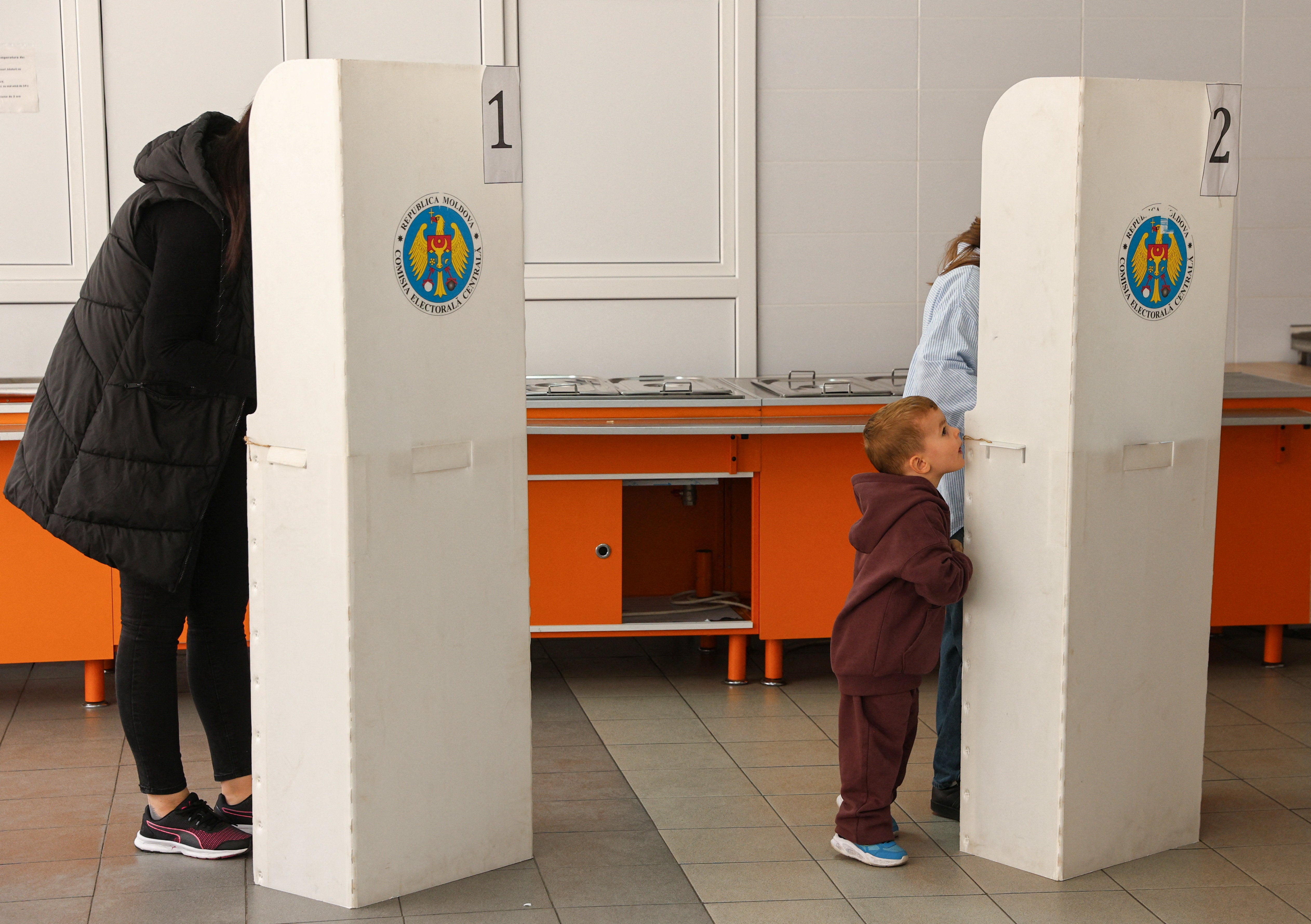 People vote at a polling station in Chisinau
