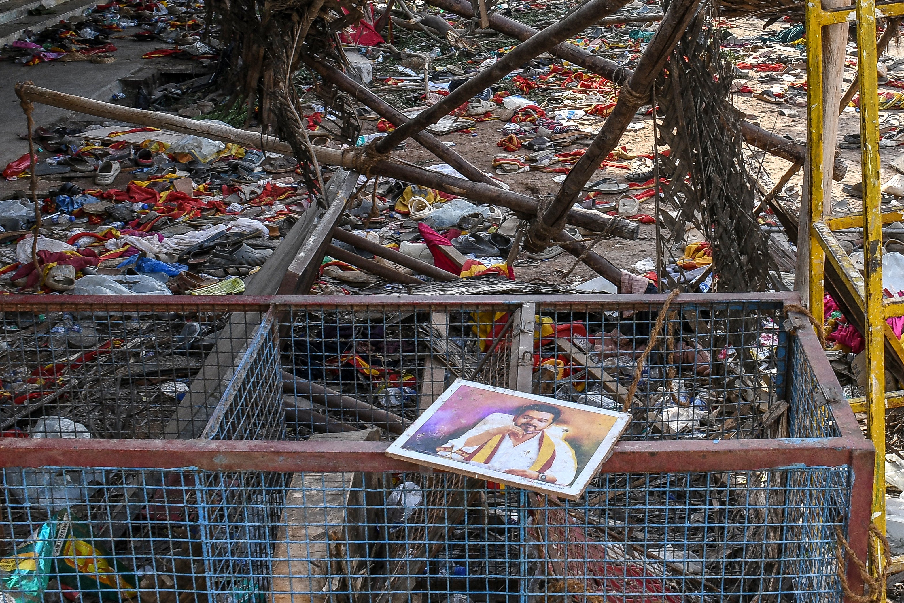 A portrait of Vijay is seen near the scattered shoes after the stampede