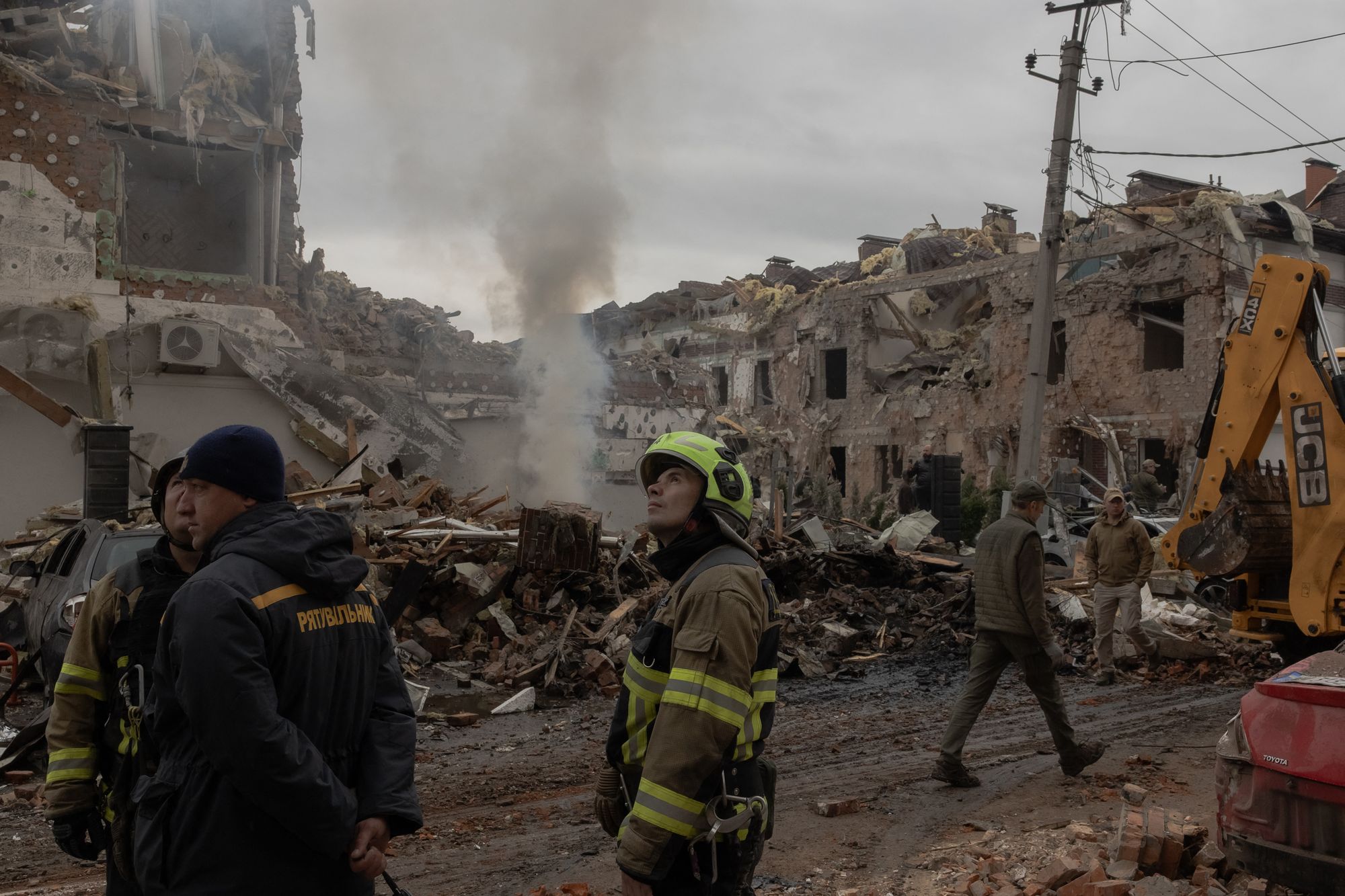 Rescuers work at the site of heavily damaged residential buildings in Kyiv