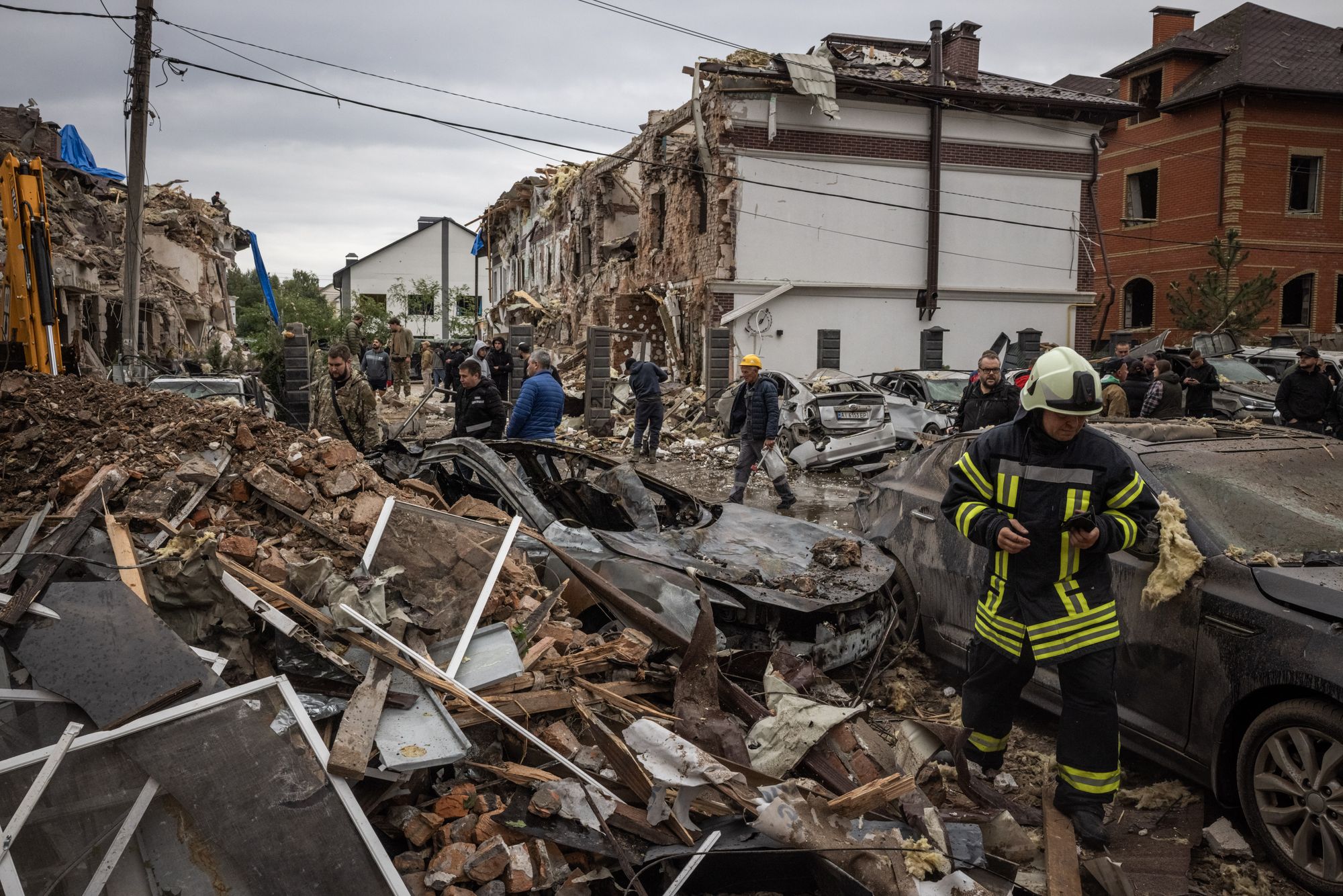 People try to clear the damage and locate their belongings at the scene of a Russian strike on 28 September in Kyiv, Ukraine