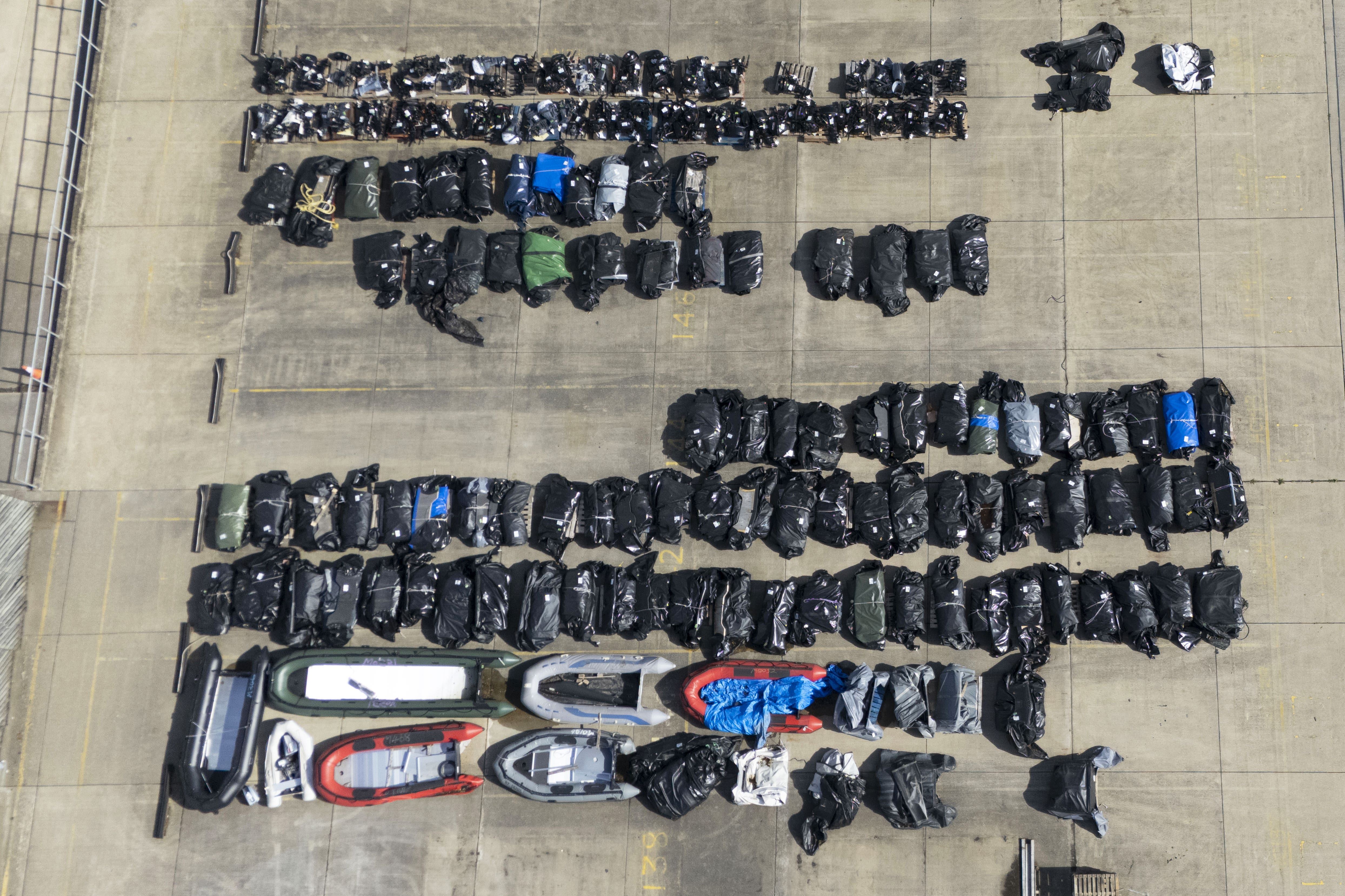 Small boats and outboard motors used by people thought to be migrants to cross the Channel from France at a warehouse facility in Dover, Kent (Gareth Fuller/PA)