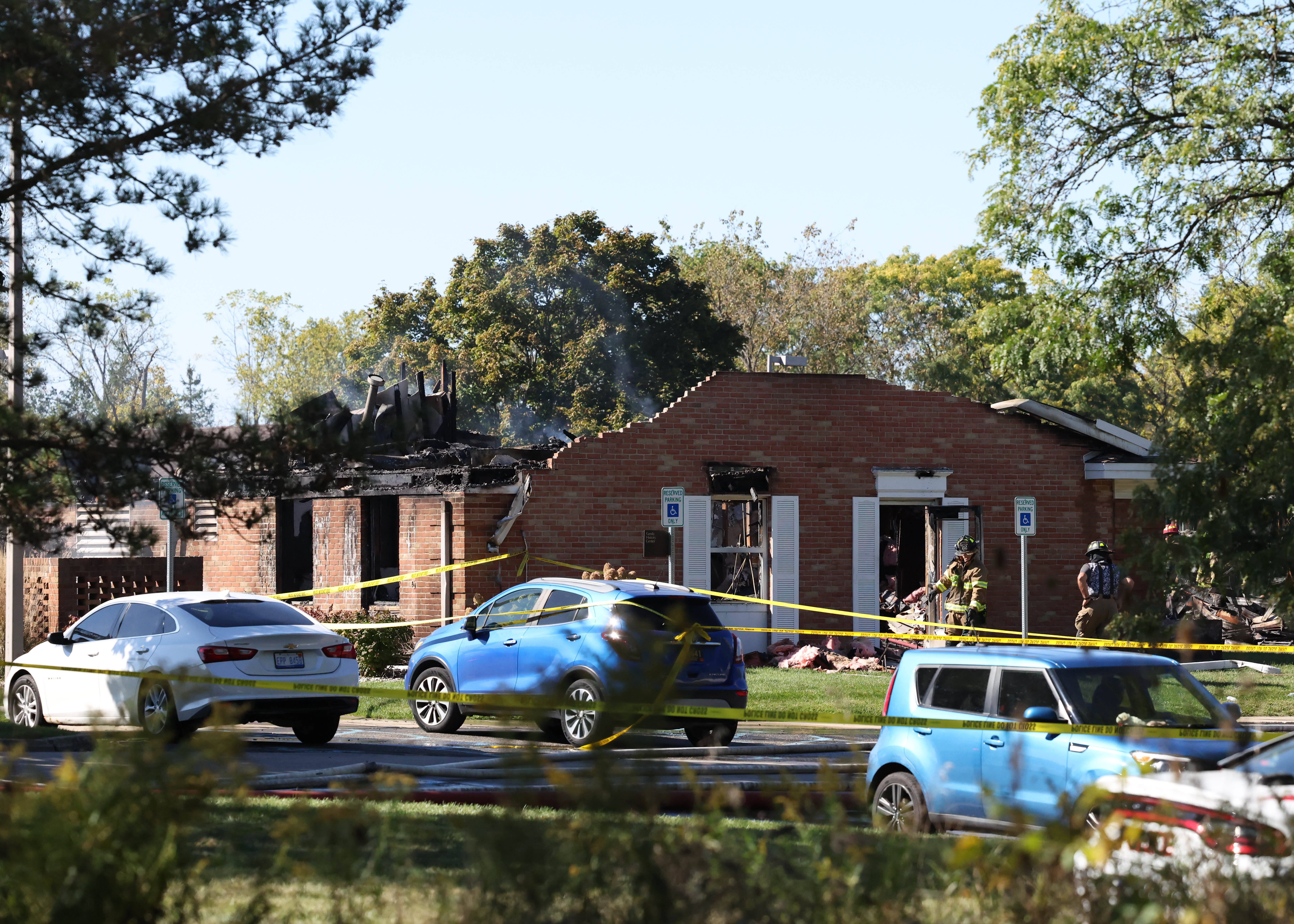 Fire and law enforcement officers stand outside the Church of Jesus Christ of Latter-day Saints, Sunday
