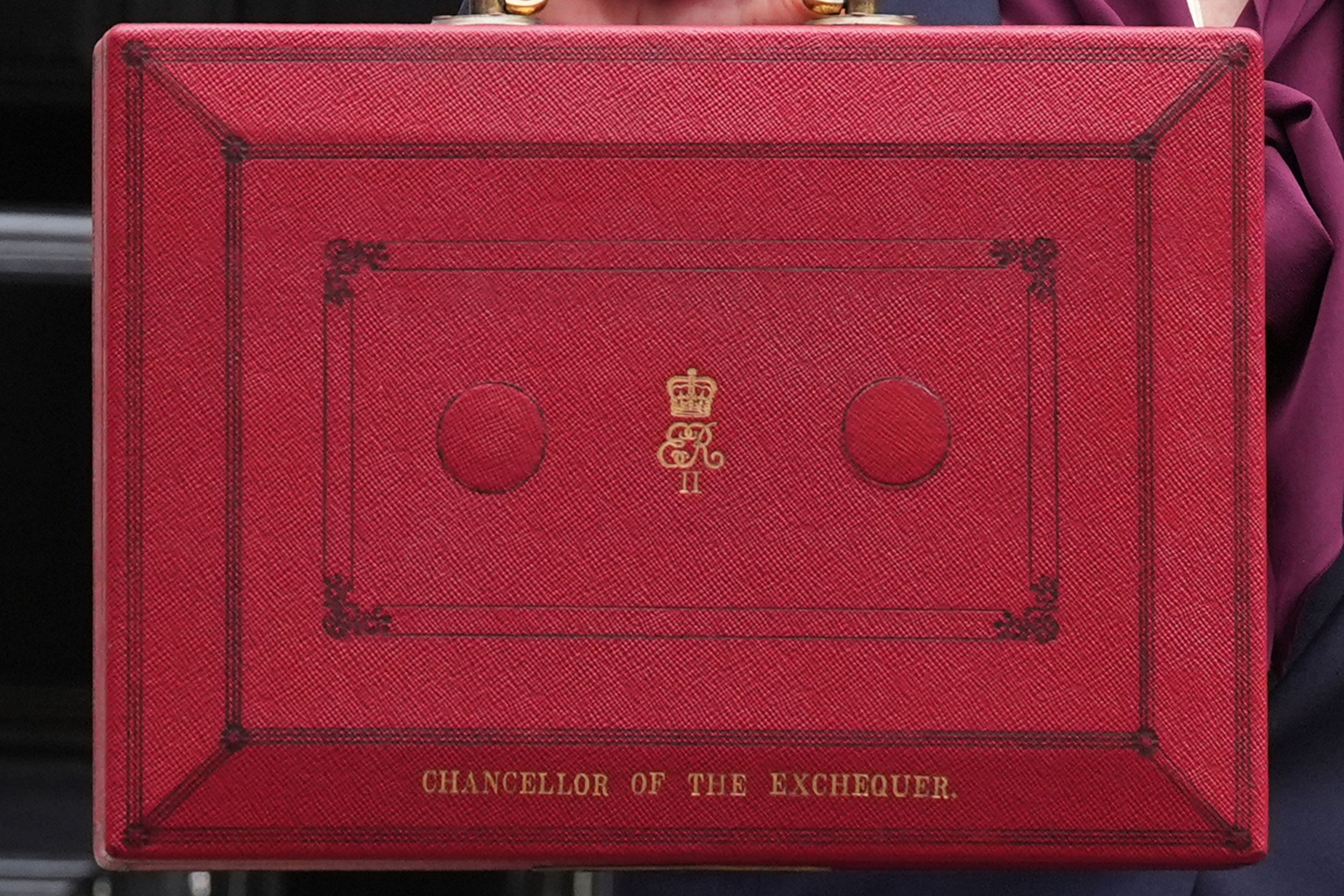 Chancellor Rachel Reeves holds up her ministerial red box in 2024