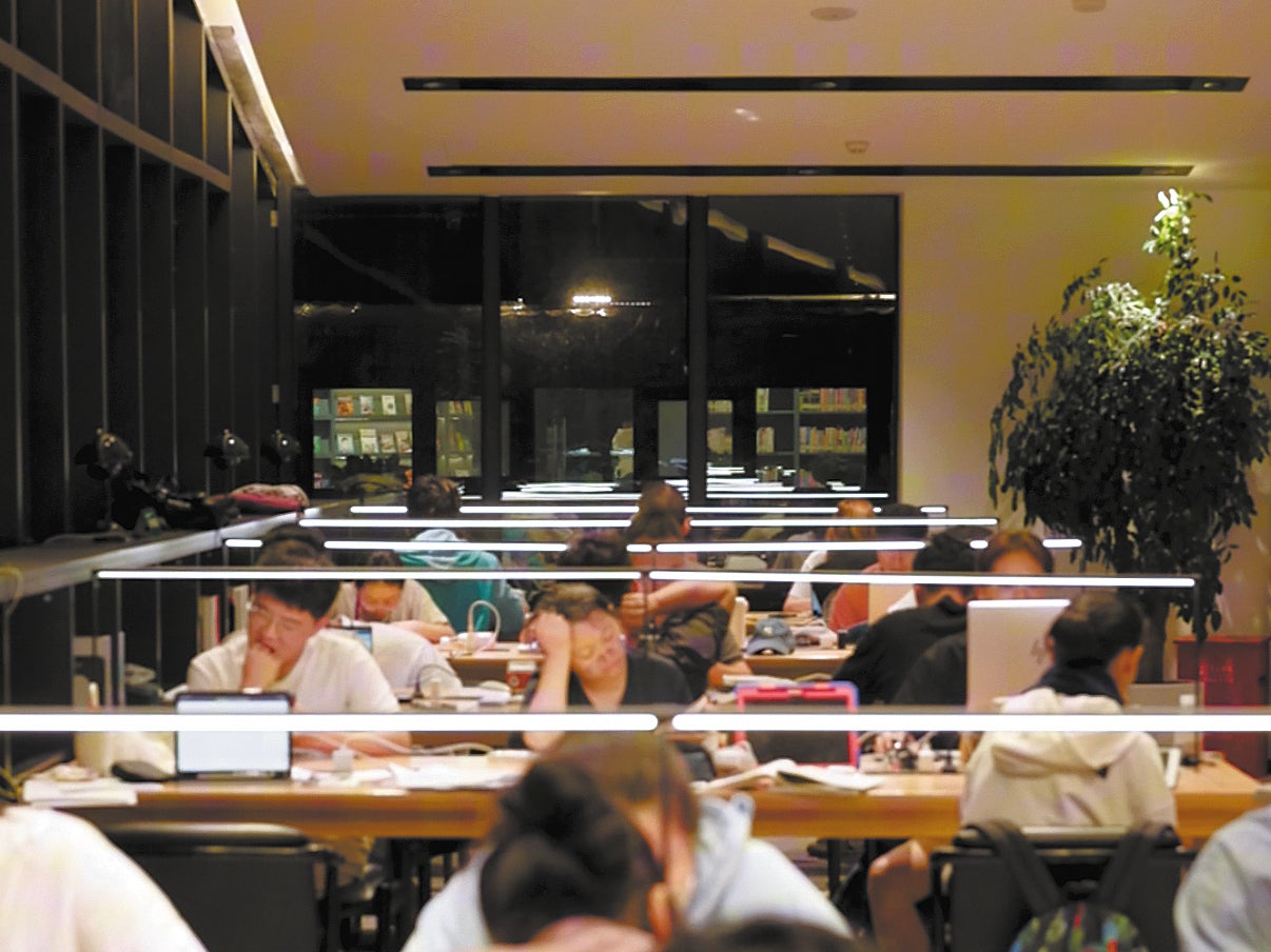 Visitors read and work at Heping Library, which is Shanghai’s first 24-hour park library