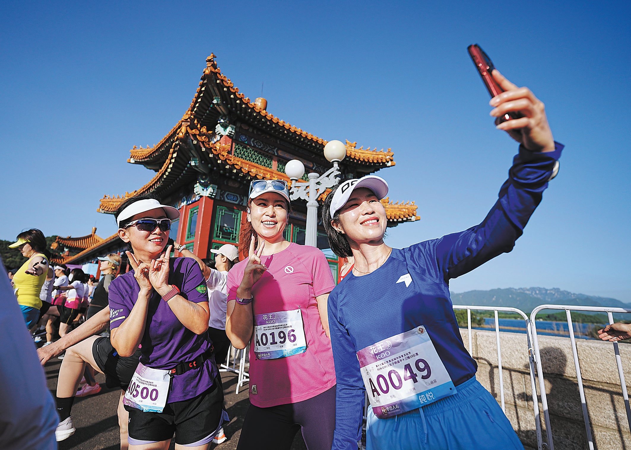 Runners take selfies during the event