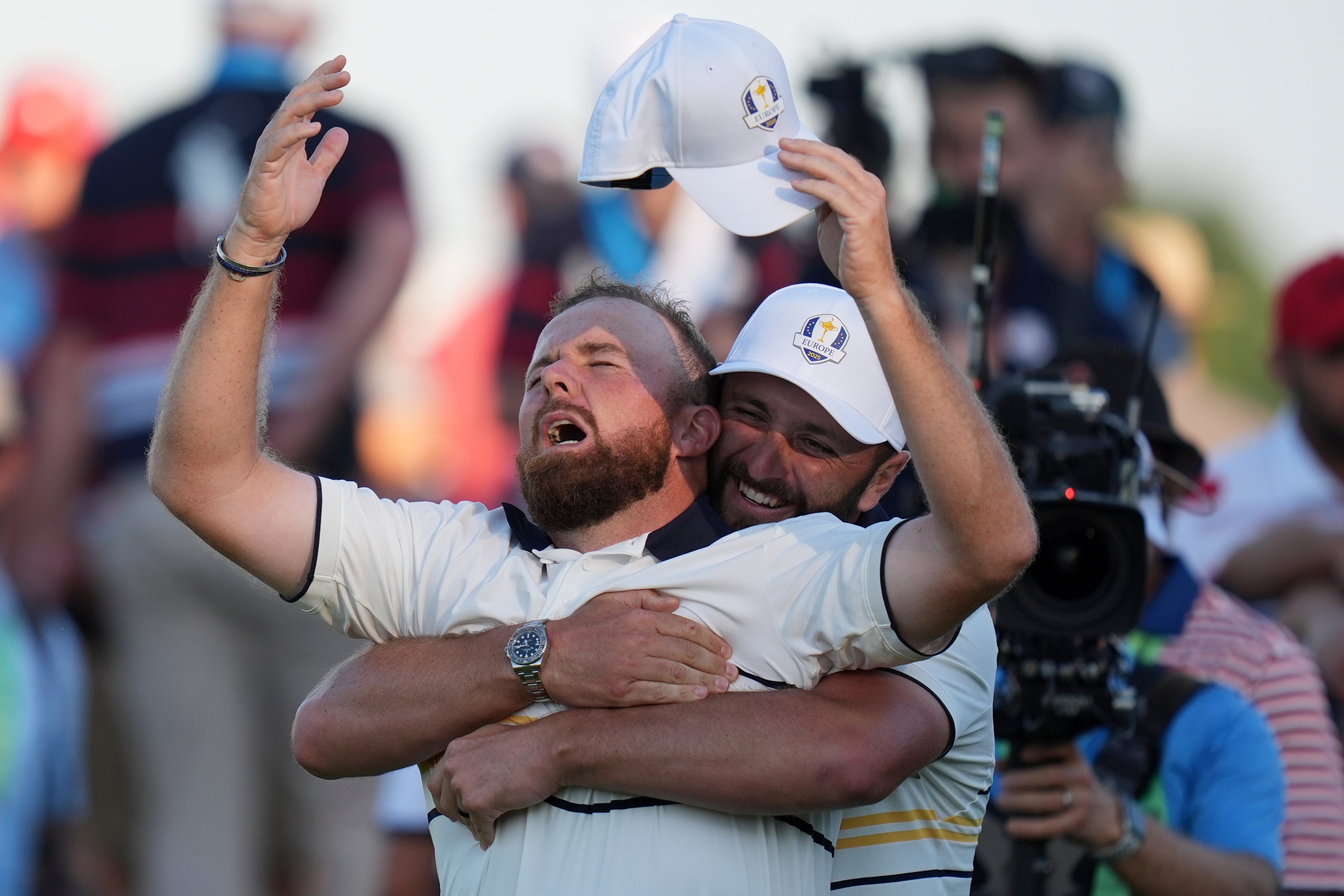 Jon Rahm cuddles Shane Lowry on the 18th green
