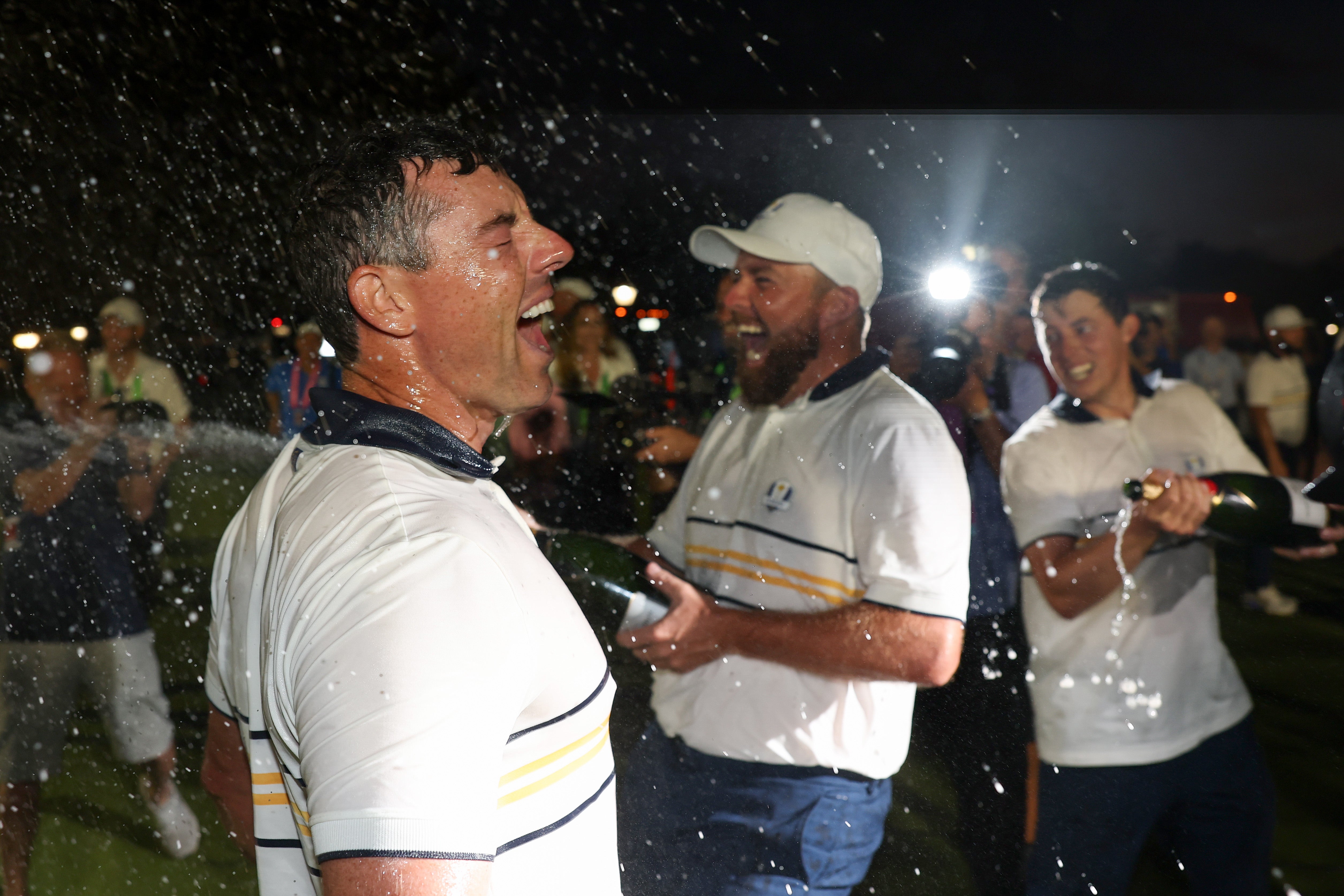 Shane Lowry blasts Rory McIlroy with champagne as the party fires up