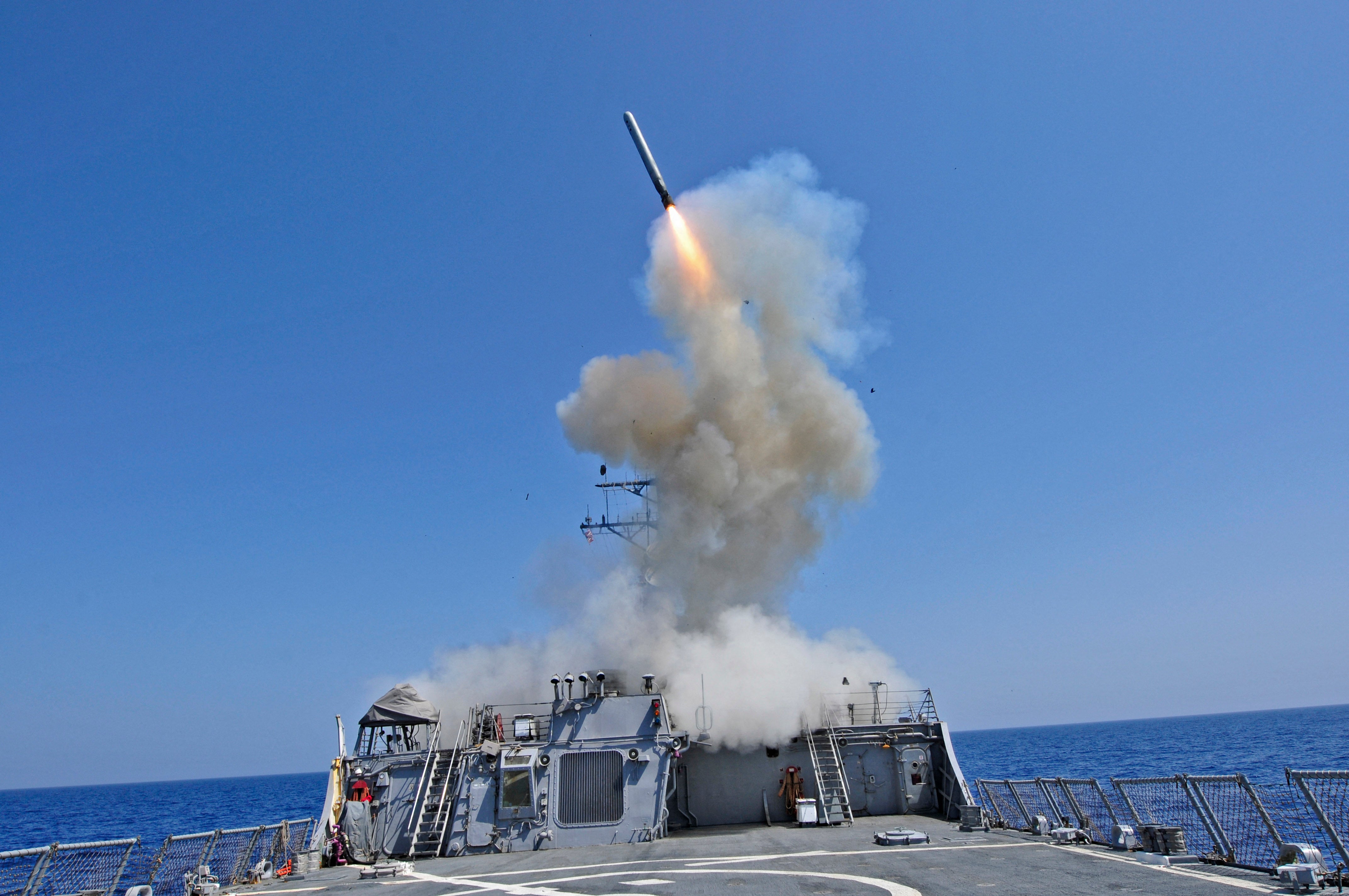The Arleigh Burke-class guided-missile destroyer USS Barry launches a Tomahawk cruise missile in the Mediterranean Sea