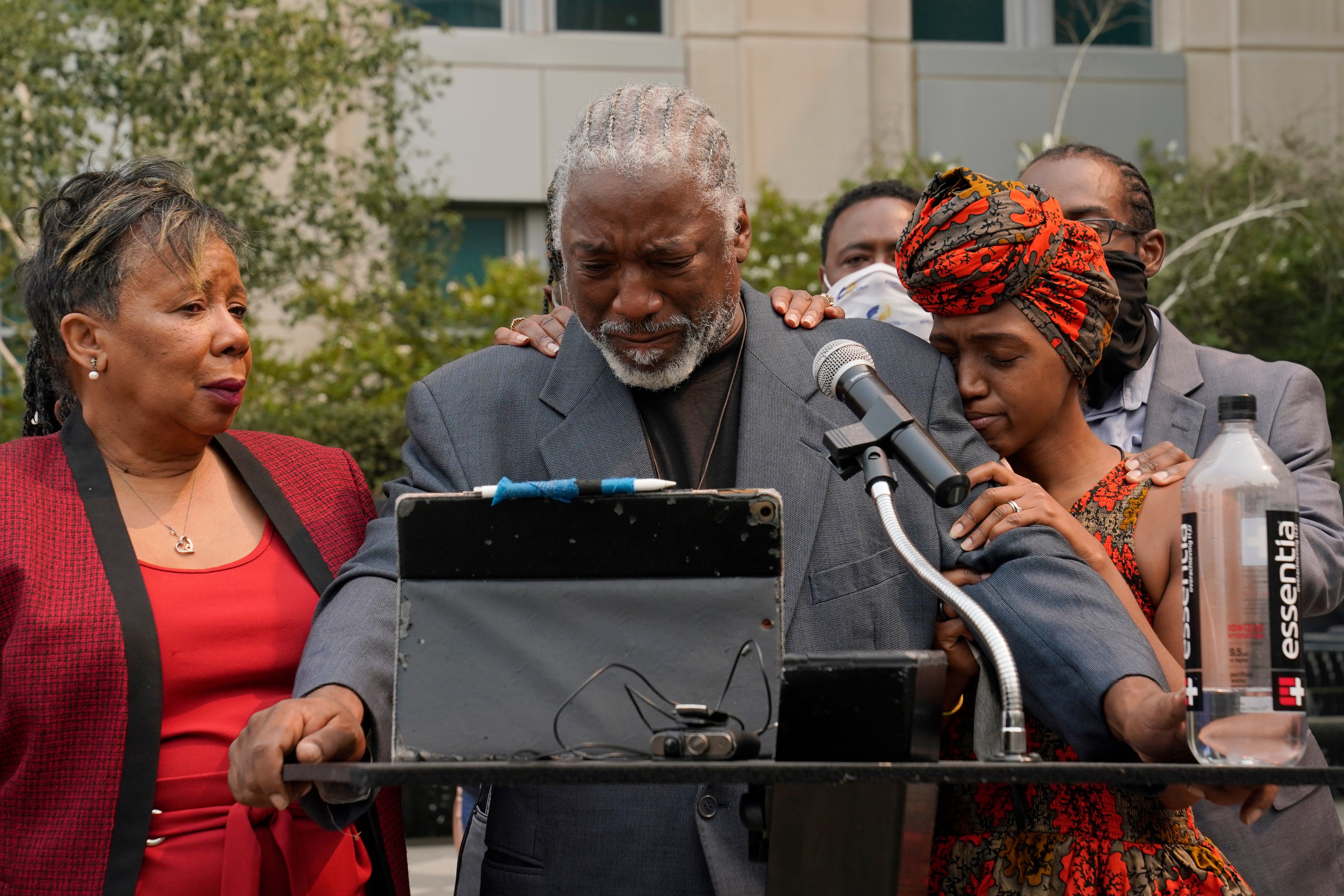 Joe Powell is comforted by his daughter, Nakia Porter, right, during a news conference to announce the filing of a federal lawsuit that was brought against two Solano County Sheriff's deputies in Sacramento