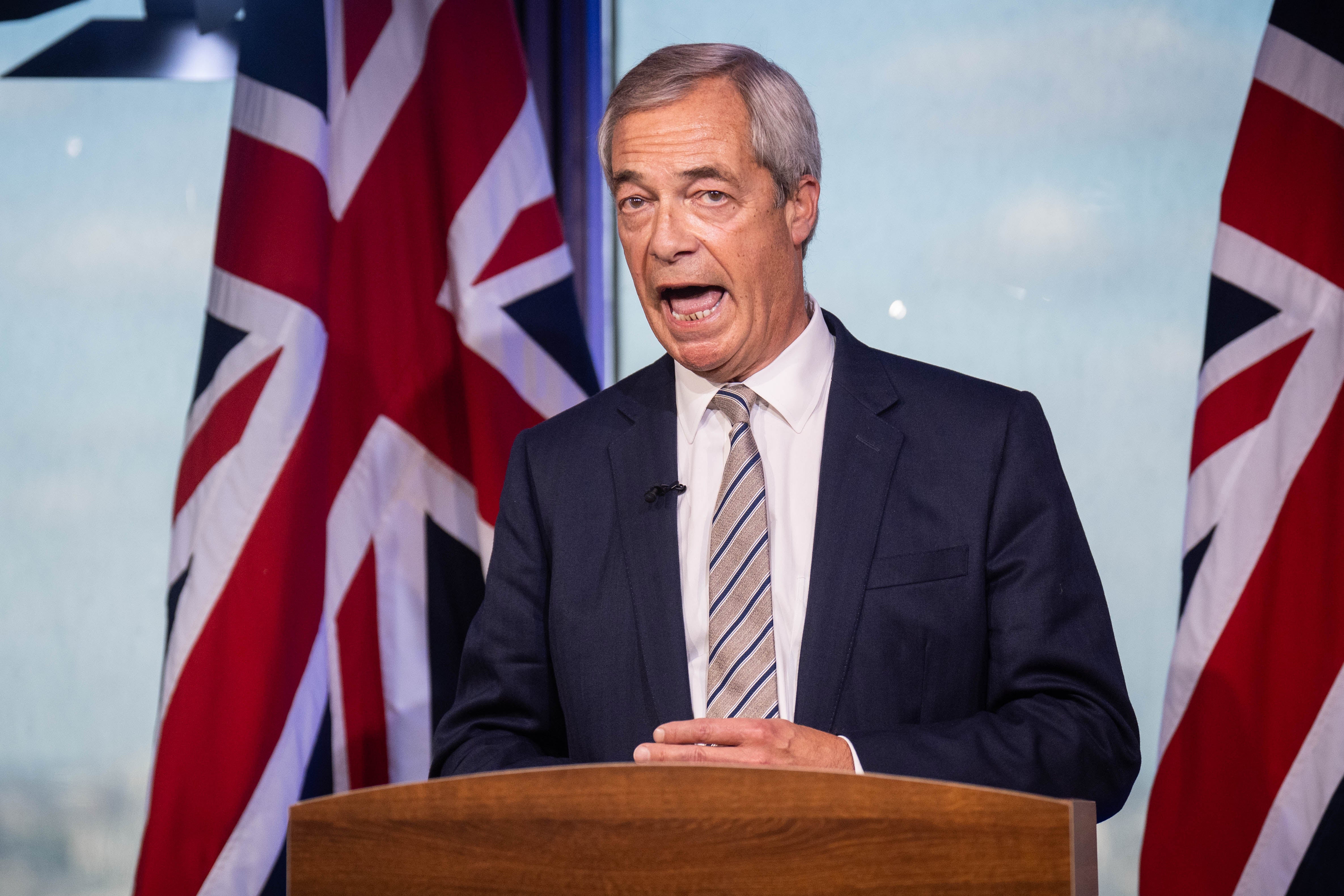 Reform UK leader Nigel Farage reacts to the speech by Prime Minister Sir Keir Starmer at the Labour Party conference, during a photocall at the Reform UK headquarters in Westminster, London
