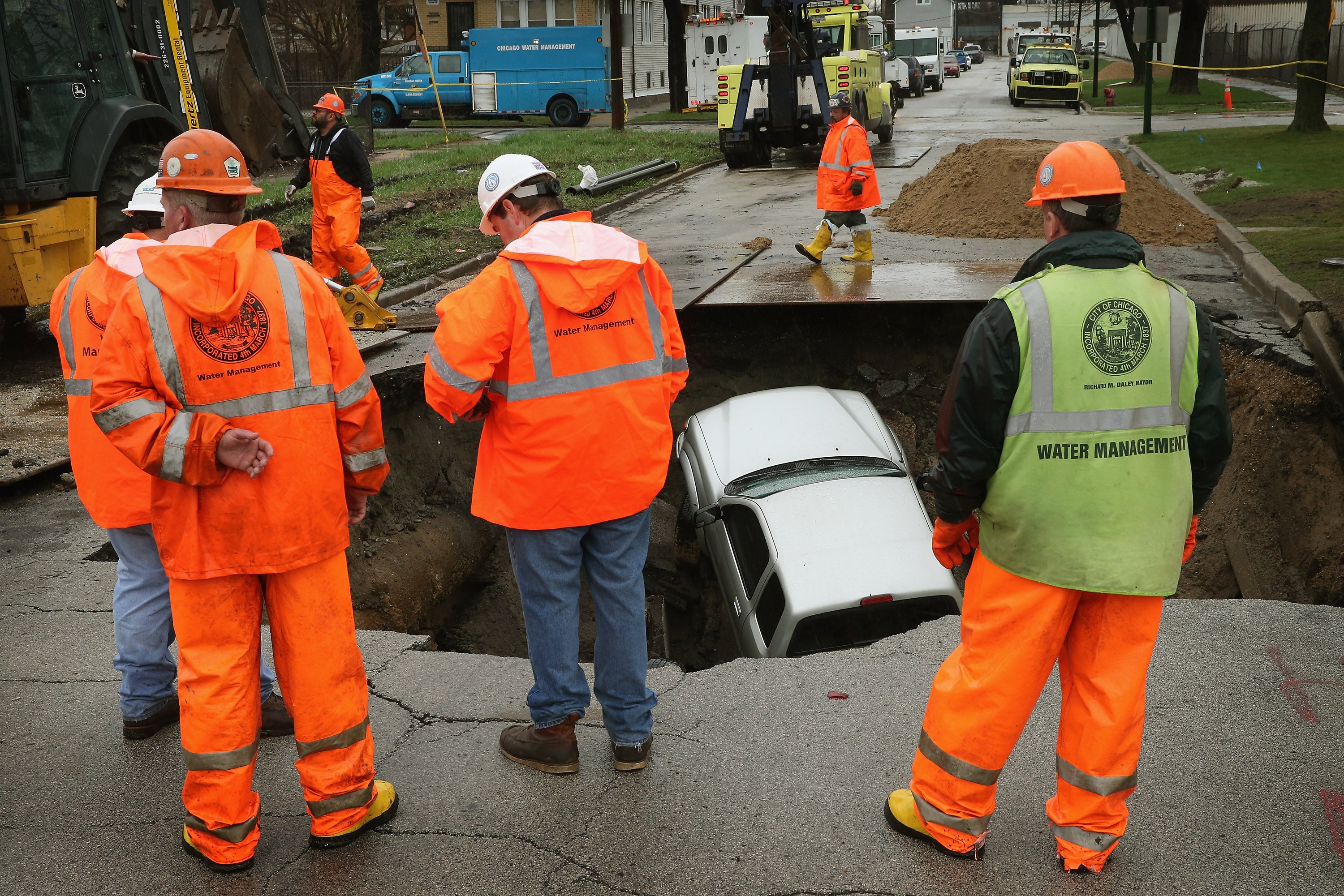 A sinkhole swallows a car on a street in Chicago, Illinois. Researchers at Penn State University say they’ve created a tool that can help predict where sinkholes might strike