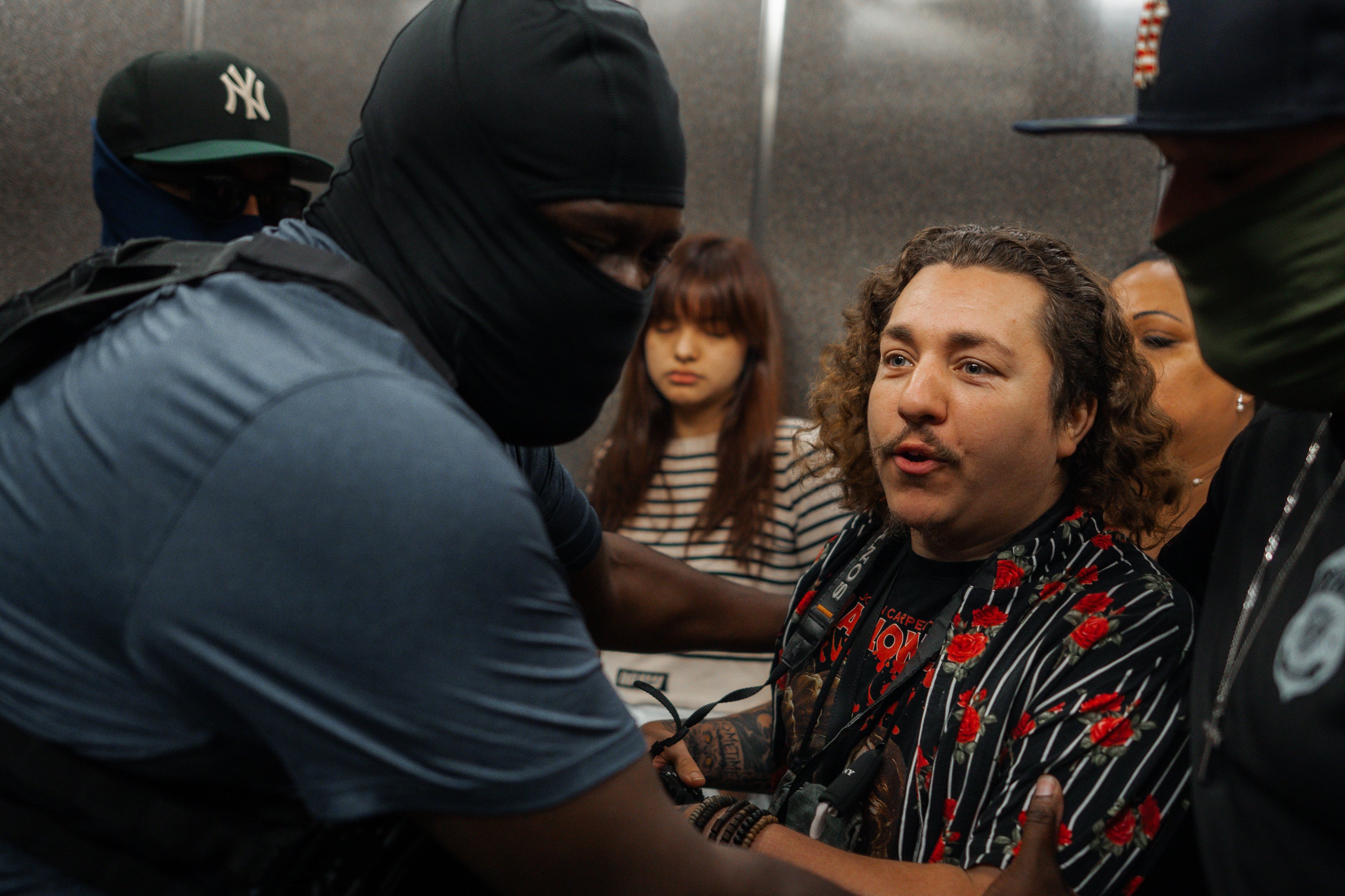 ICE agents wrangle amNewYork reporter Dean Moses out of an elevator and shoved several reporters and photographers