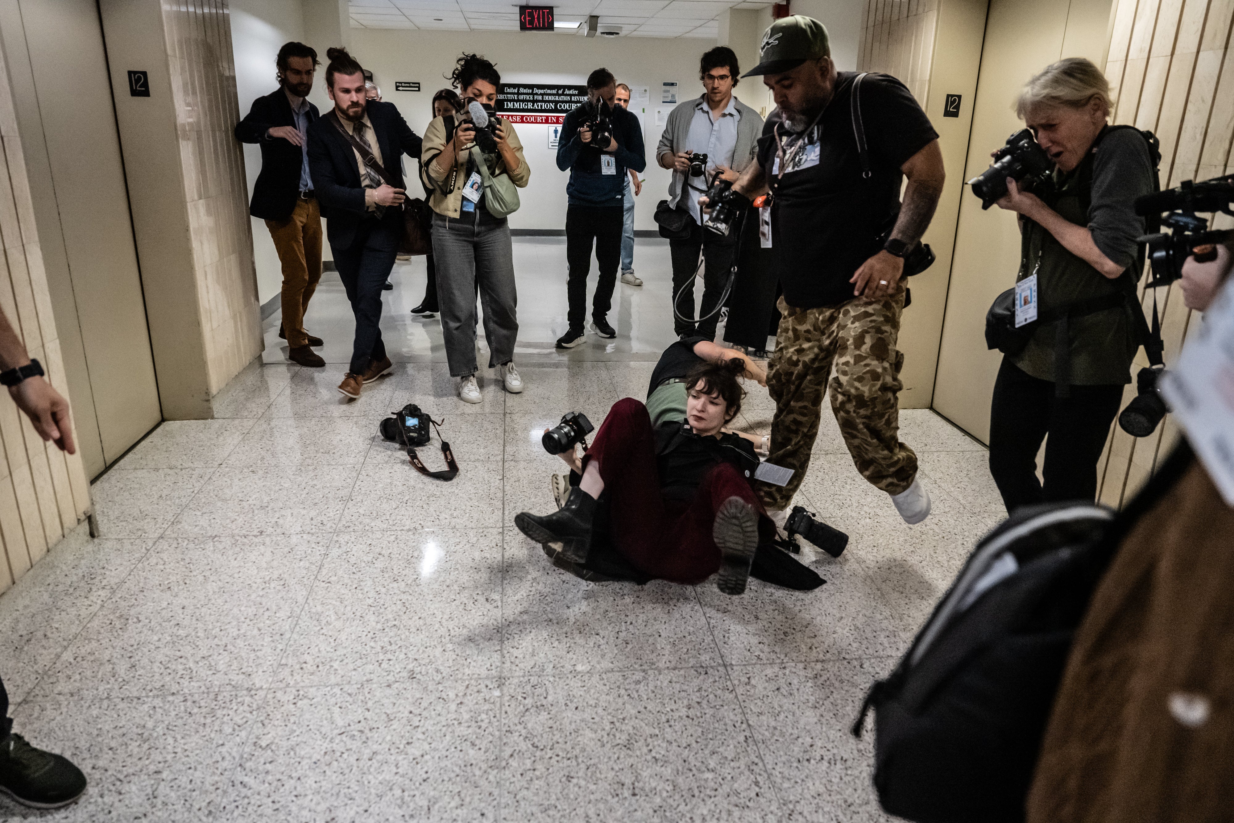 Federal agents shove Associated Press freelance photographer Olga Fedorova on September 30 inside an immigration courthouse in downtown Manhattan