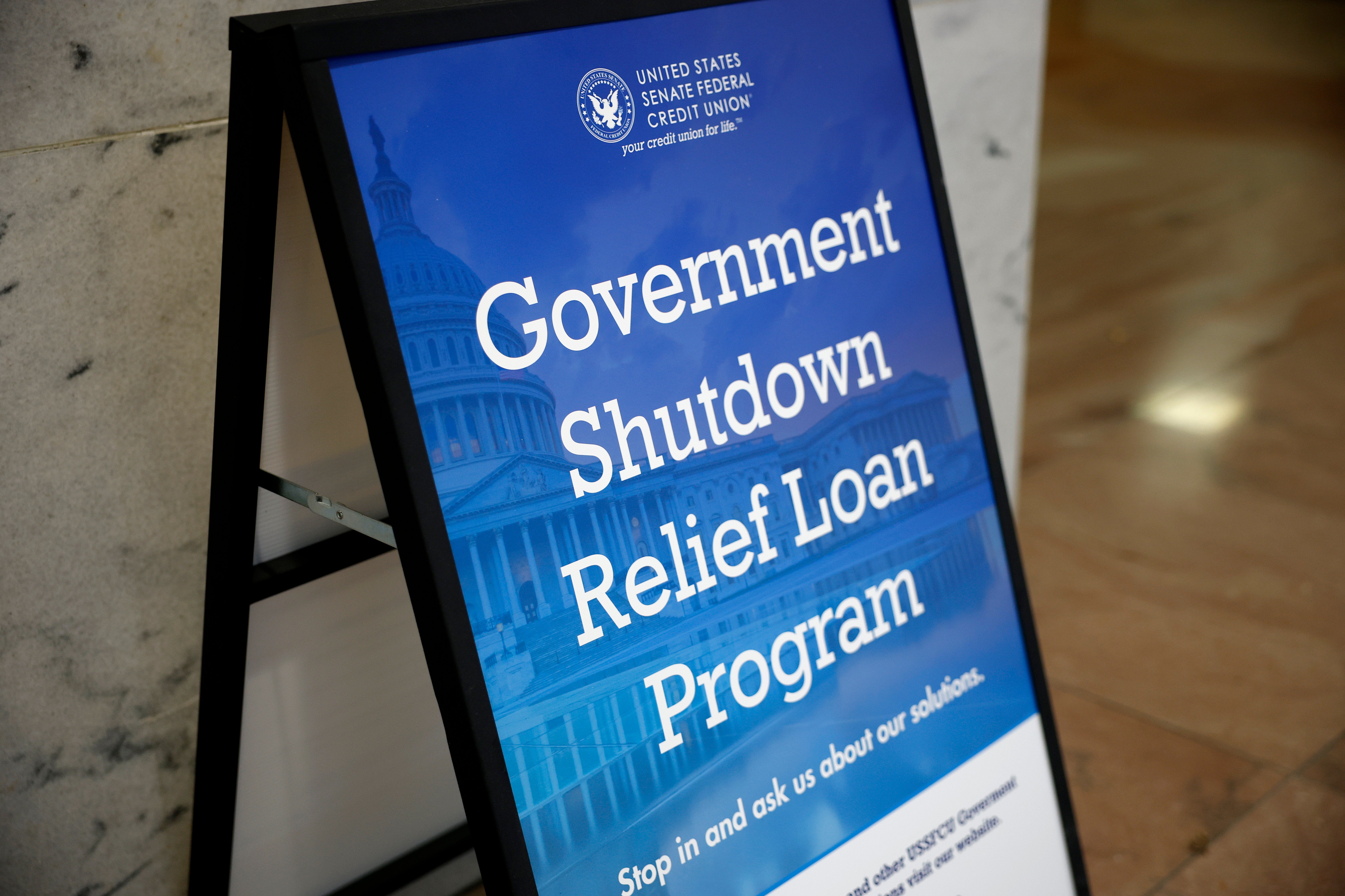A sign advertising a government shutdown relief loan is seen outside of the U.S. Senate Federal Credit Union in the Hart Senate Office Building as a government shutdown loomed Tuesday.