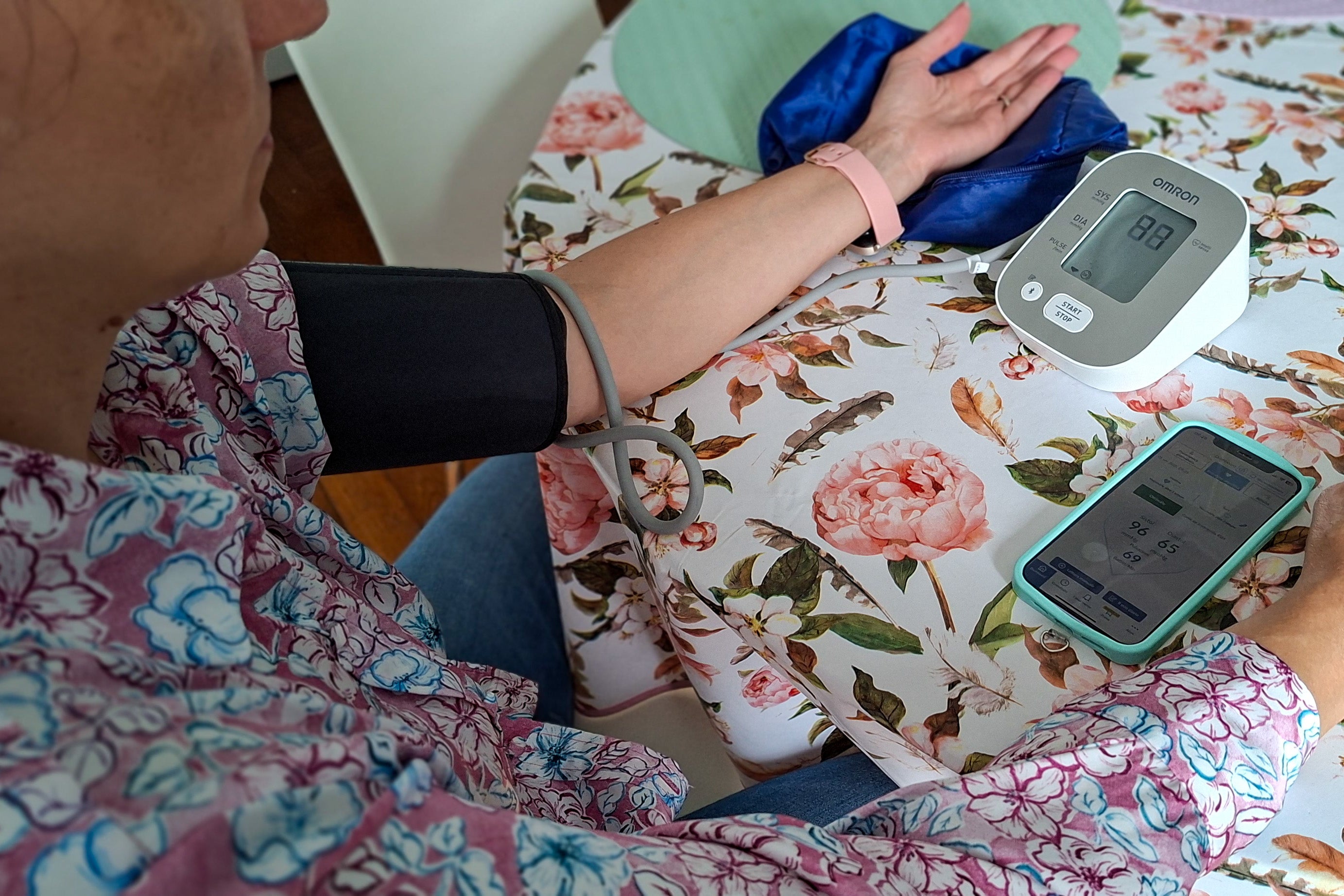 A woman uses a blood pressure monitor at her home in Paris, France