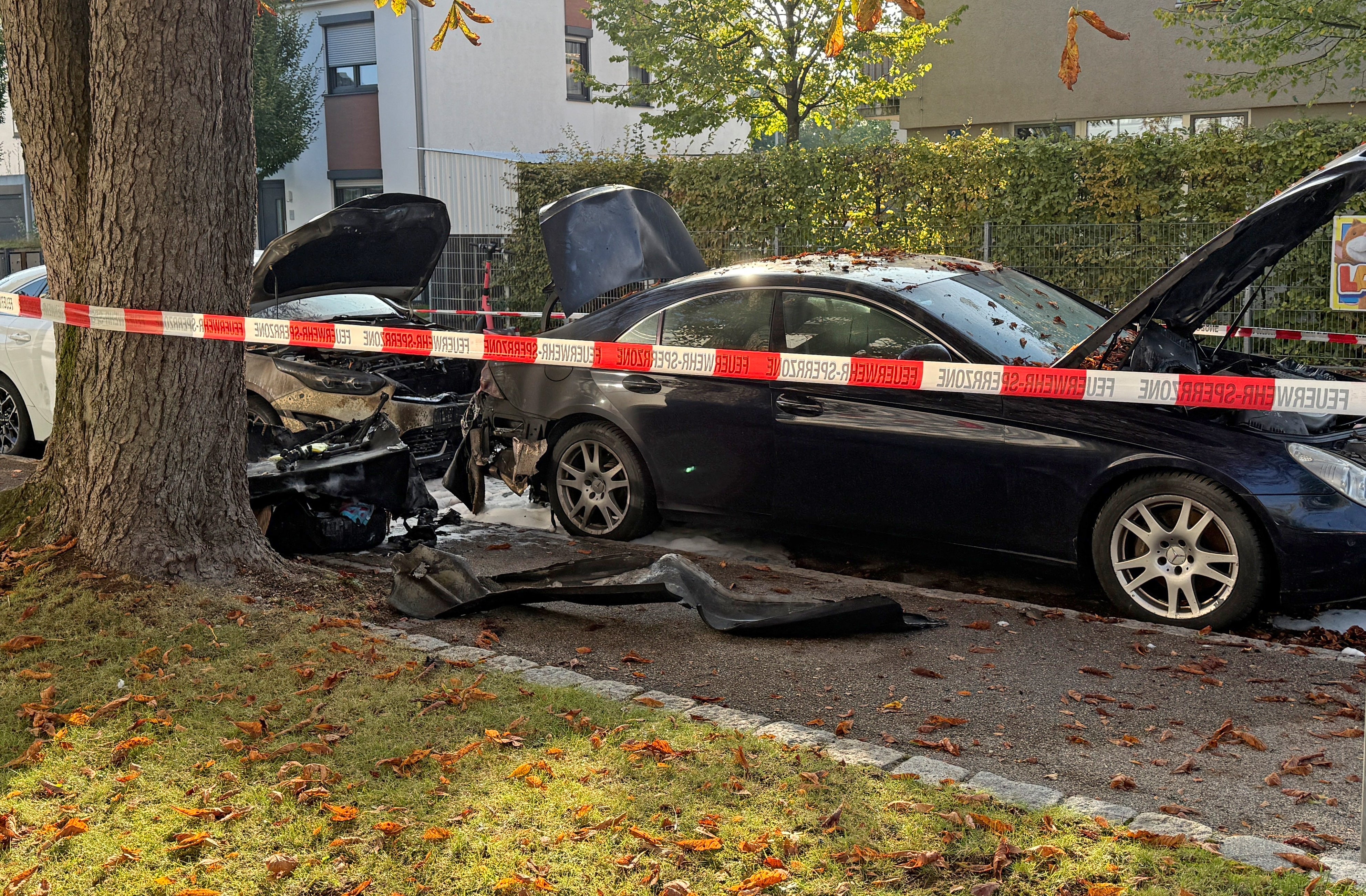 Burned cars are seen in a street after a fire in Munich, Germany, Wednesday, Oct. 1, 2025