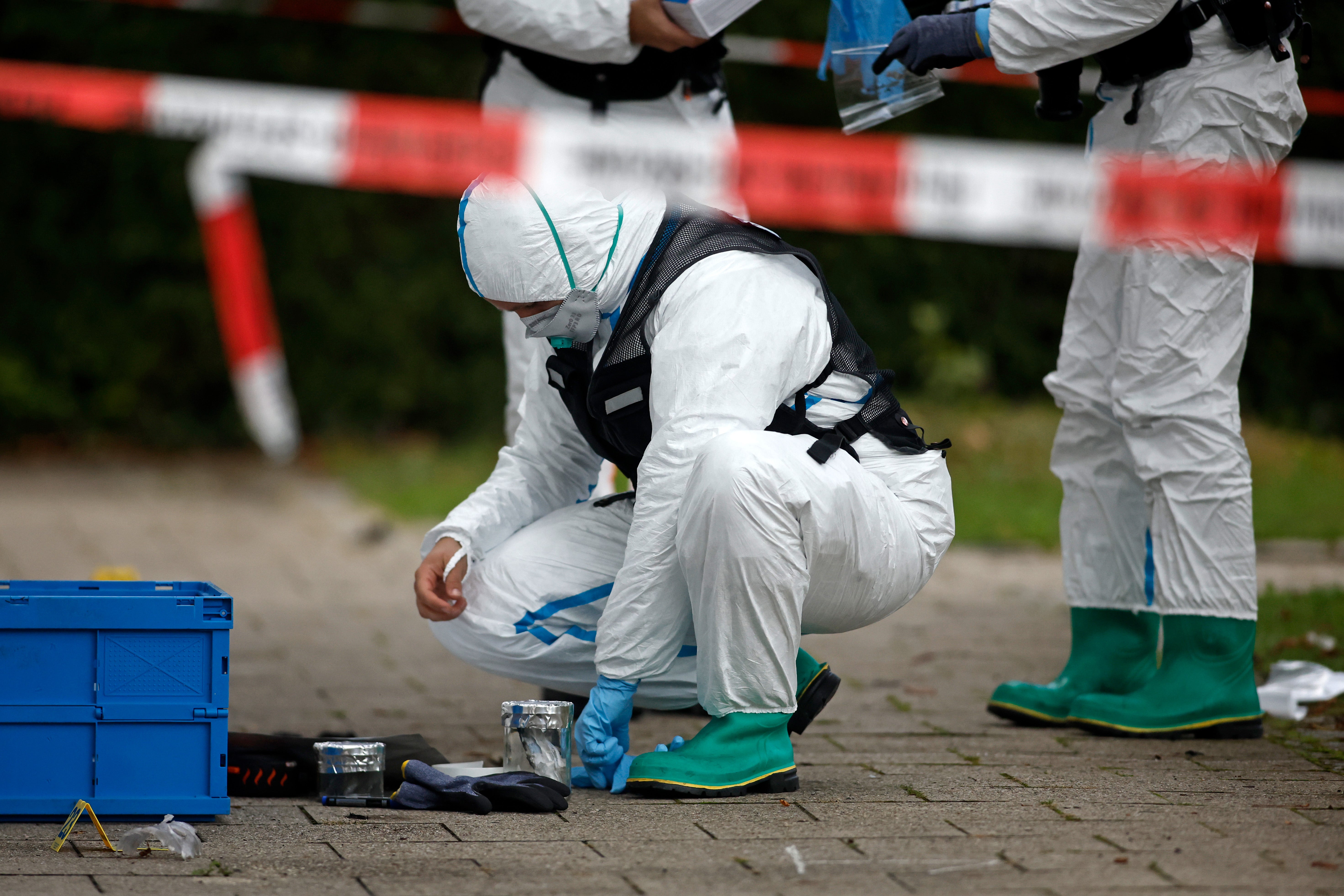Authorities investigate the scene of a car fire in Munich, Germany, on Wednesday