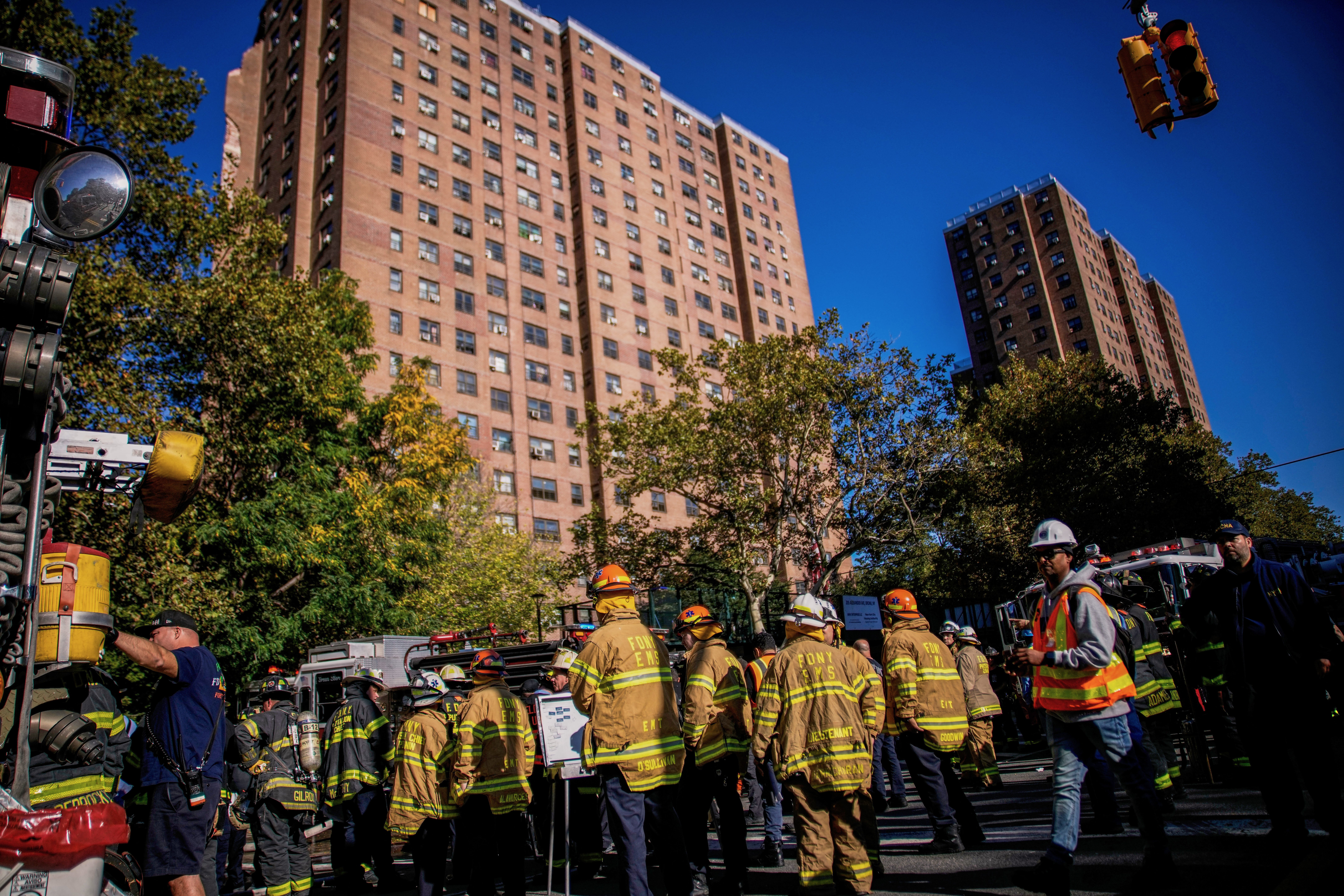 Firefighters work near the site of the building collapse
