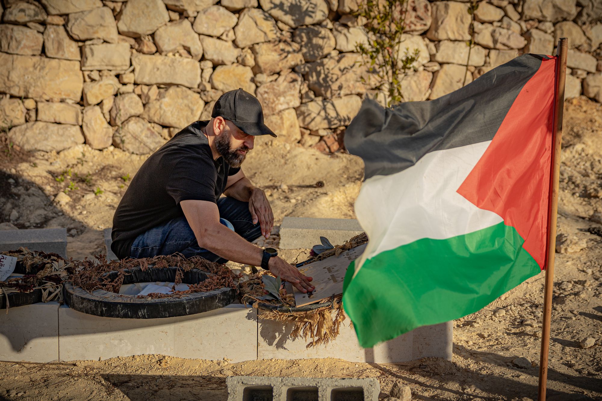 Kamel Musallet prays by his son’s grave in the West Bank