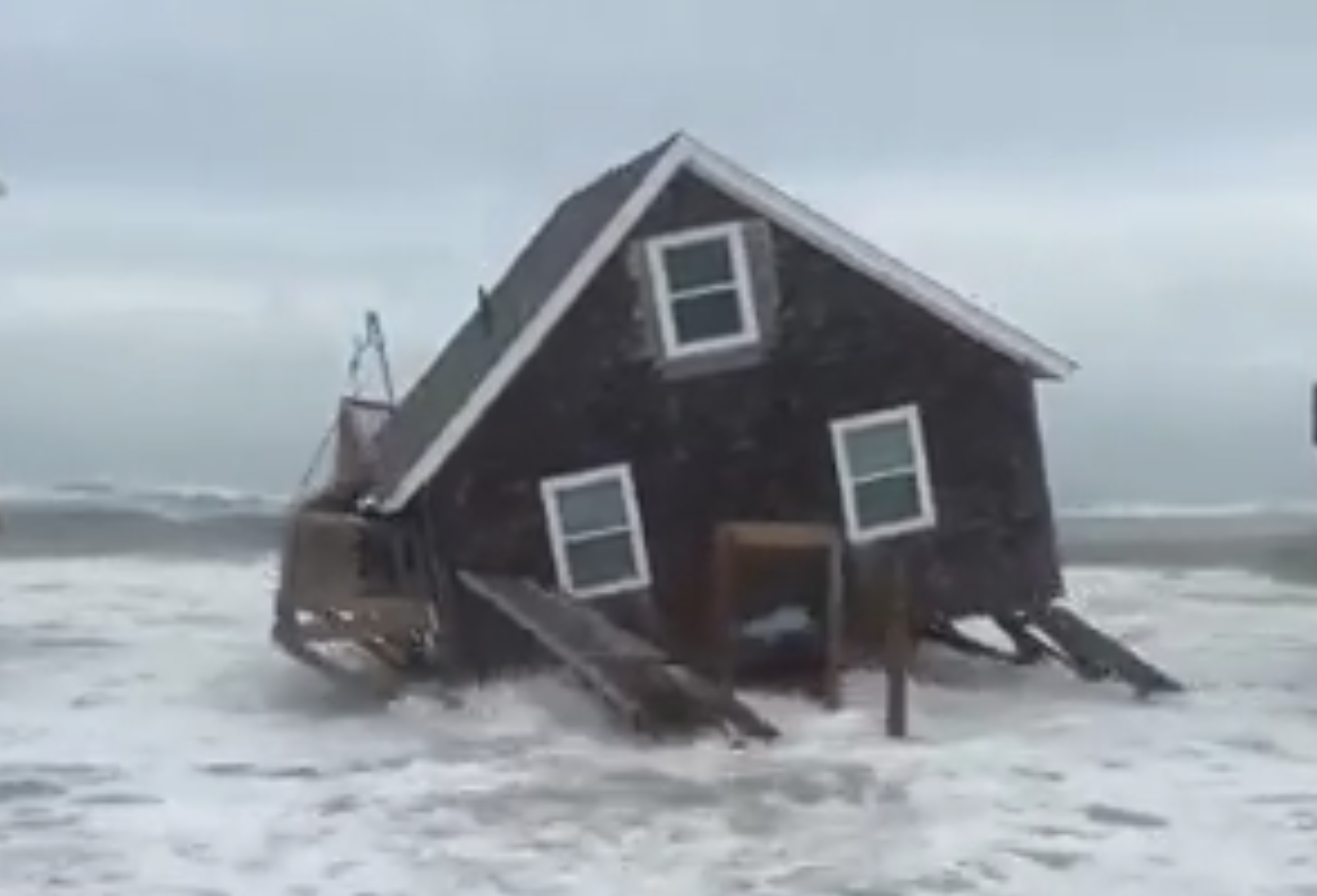 A house in the Outer Banks, North Carolina, collapses into the sea as Hurricanes Humberto and Imelda churn in the Atlantic Ocean off the U.S. East Coast. Six homes collapsed along the shoreline on September 30