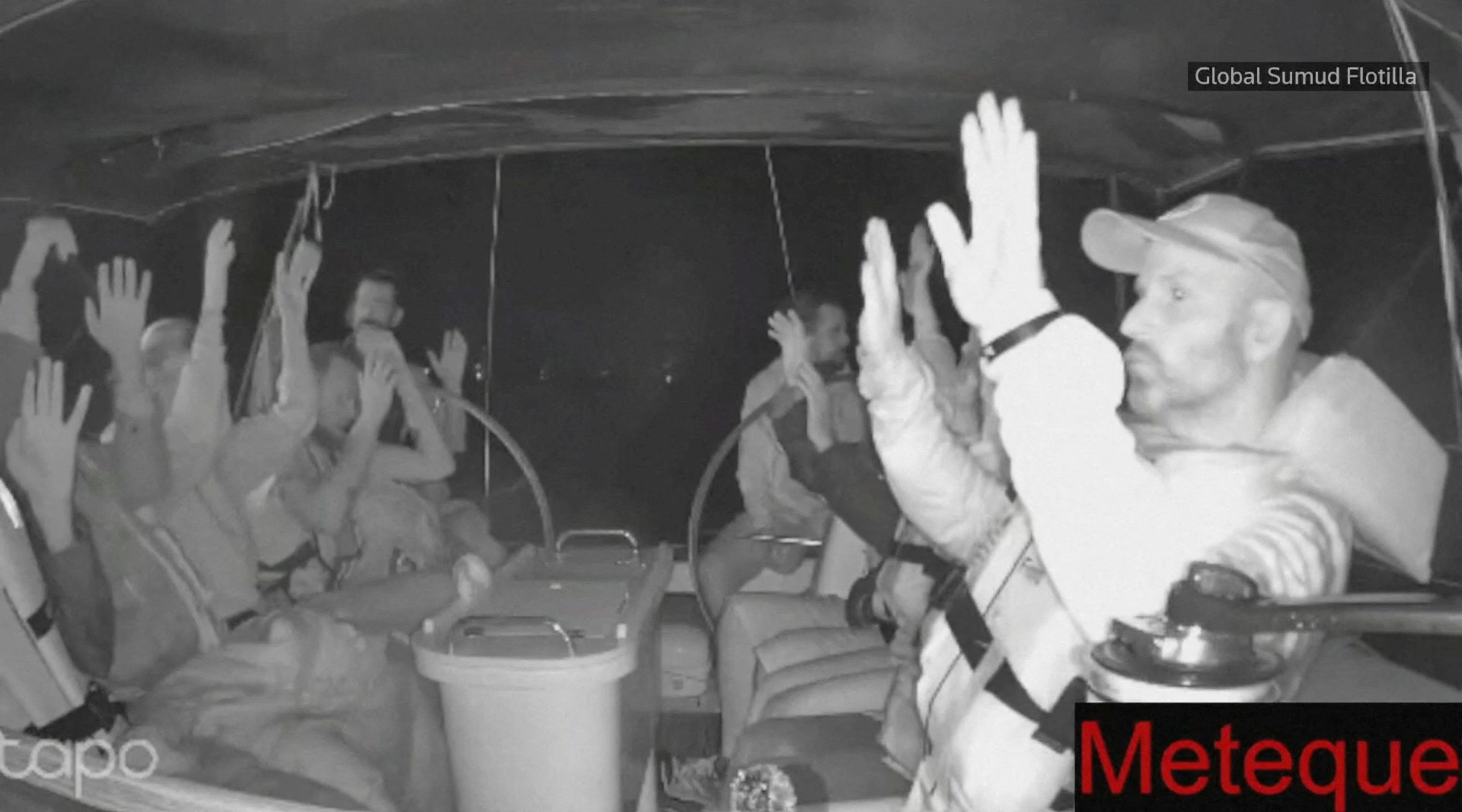 A screengrab from a live footage video shows crew of a Gaza-bound vessel, part of the Global Sumud Flotilla, put their hands up as they are intercepted by Israeli security forces