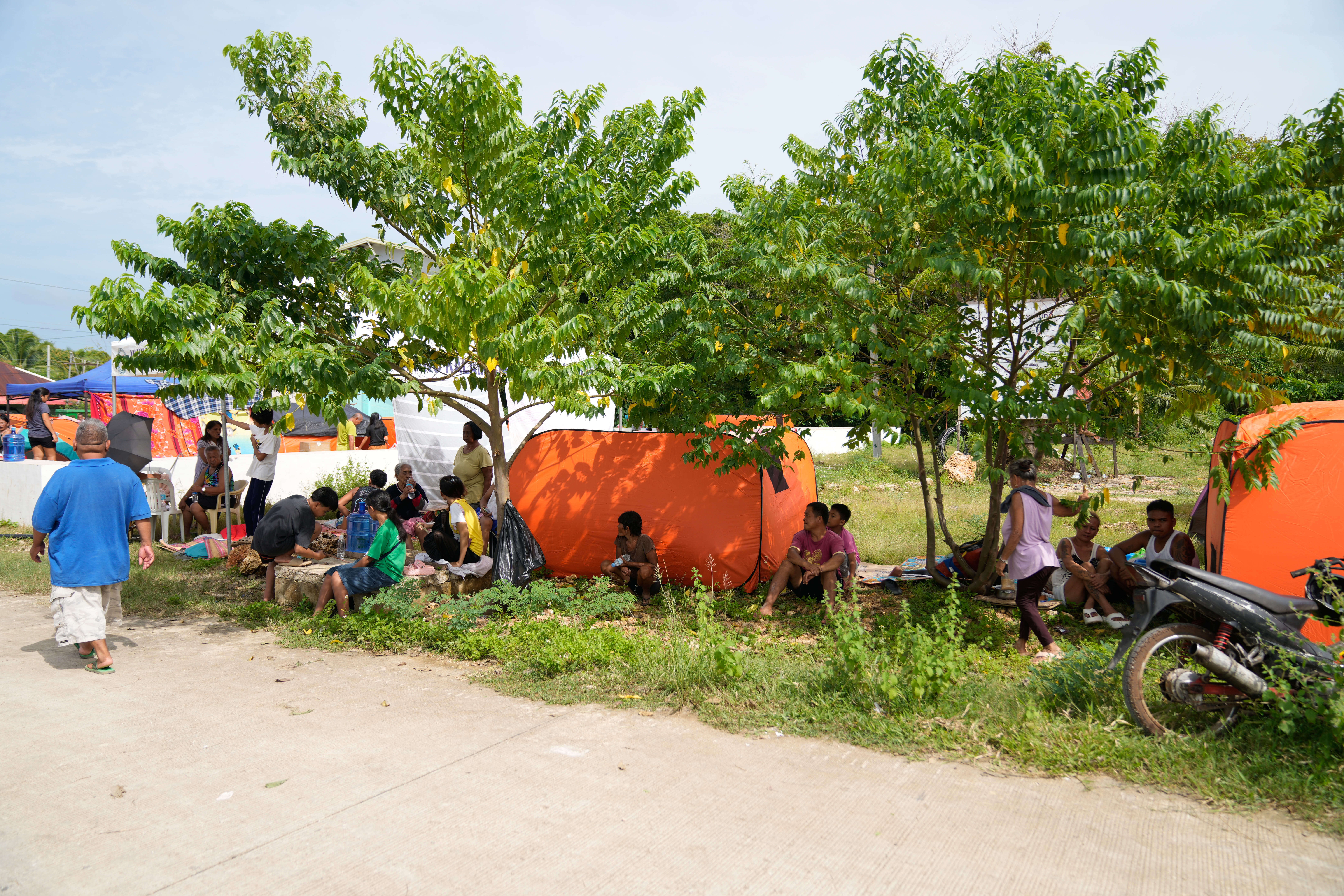 Survivors of Tuesday's earthquake stay in open spaces in San Remigio, Cebu Province