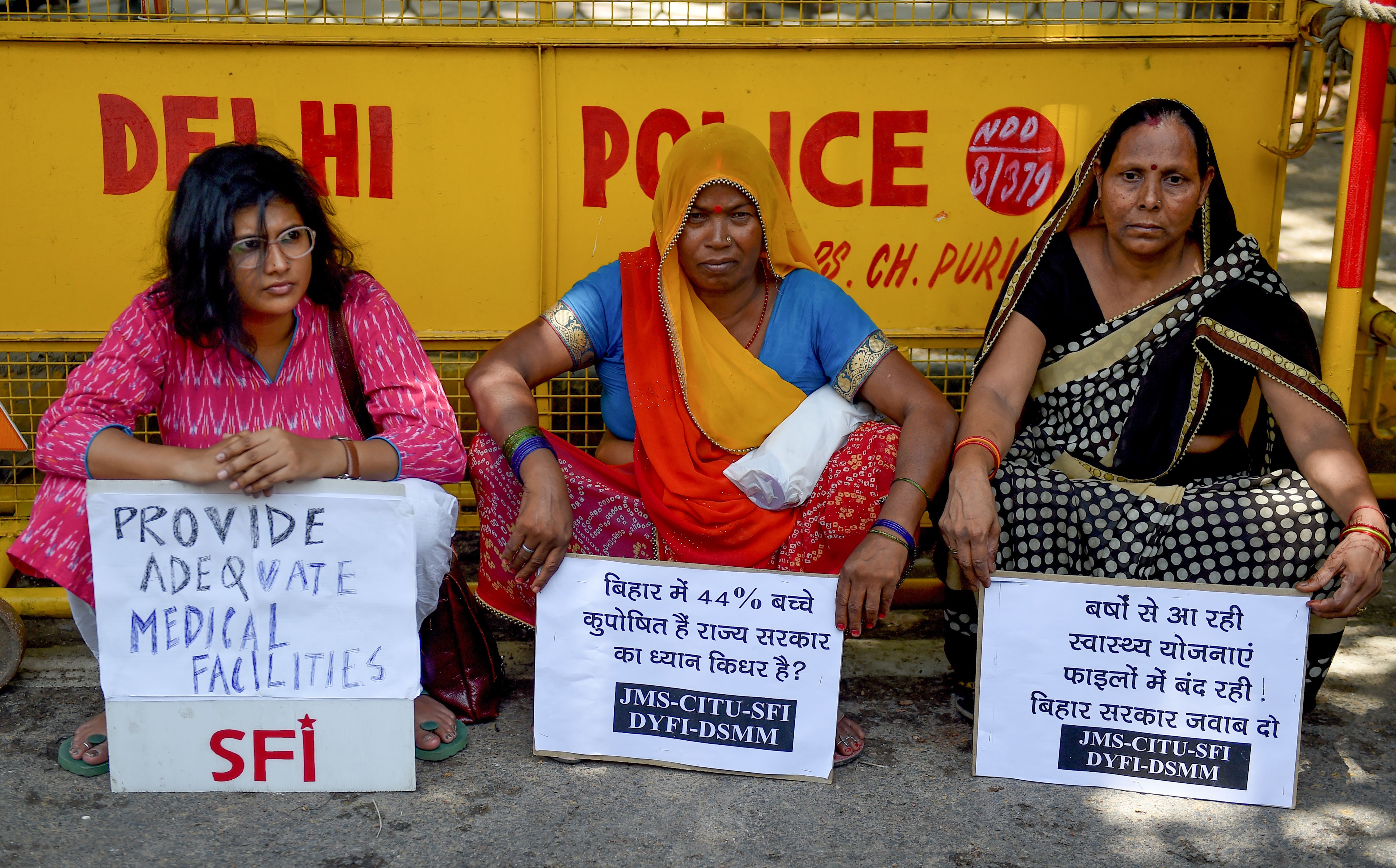File. Indian women activists hold placards during a protest seeking adequate medical facilities
