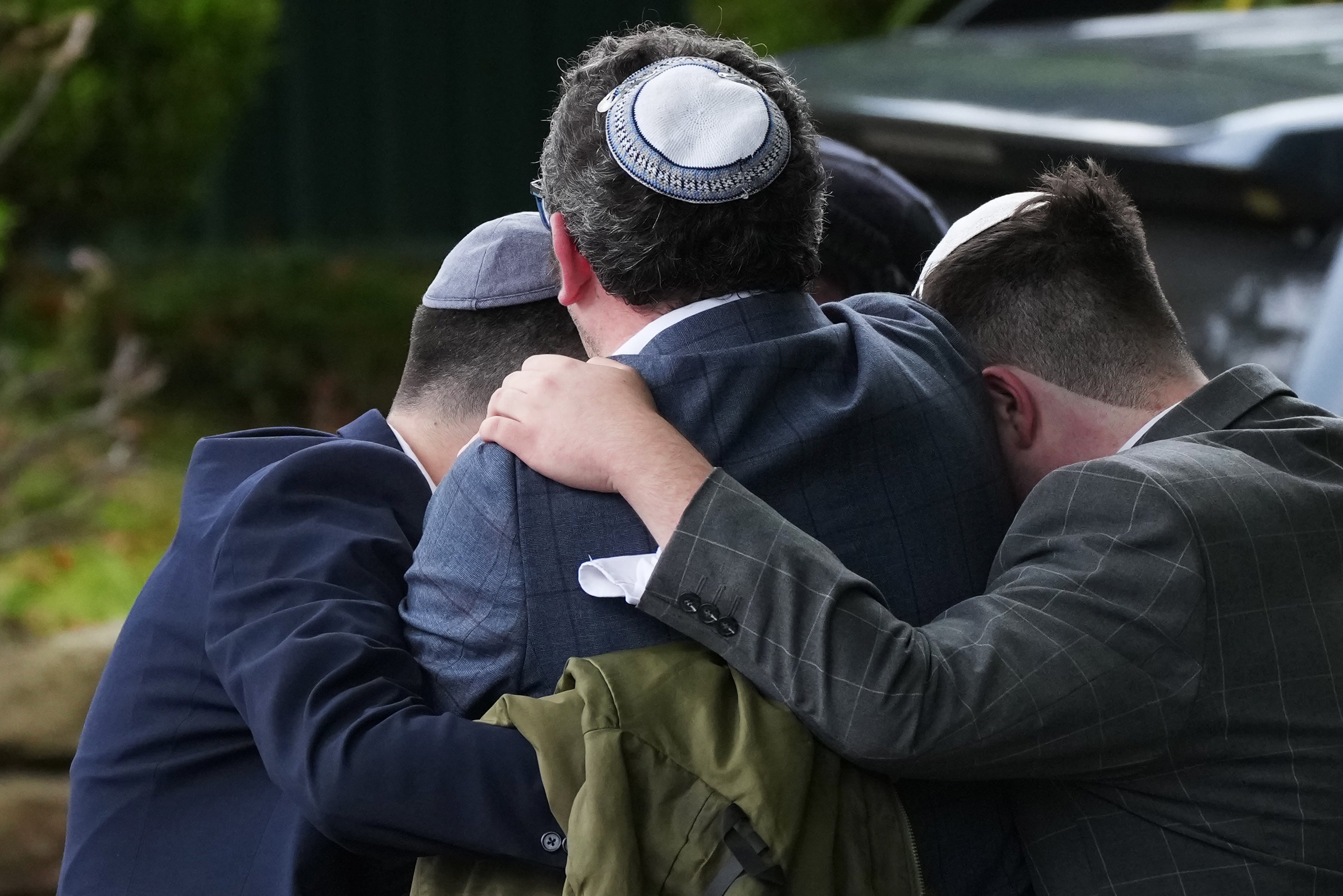 Members of the public react as they gather near the Heaton Park Hebrew Congregation Synagogue, where multiple were injured after stabbing and car attack on Yom Kippur, on October 2, 2025 in the Crumpsall suburb of Manchester, England