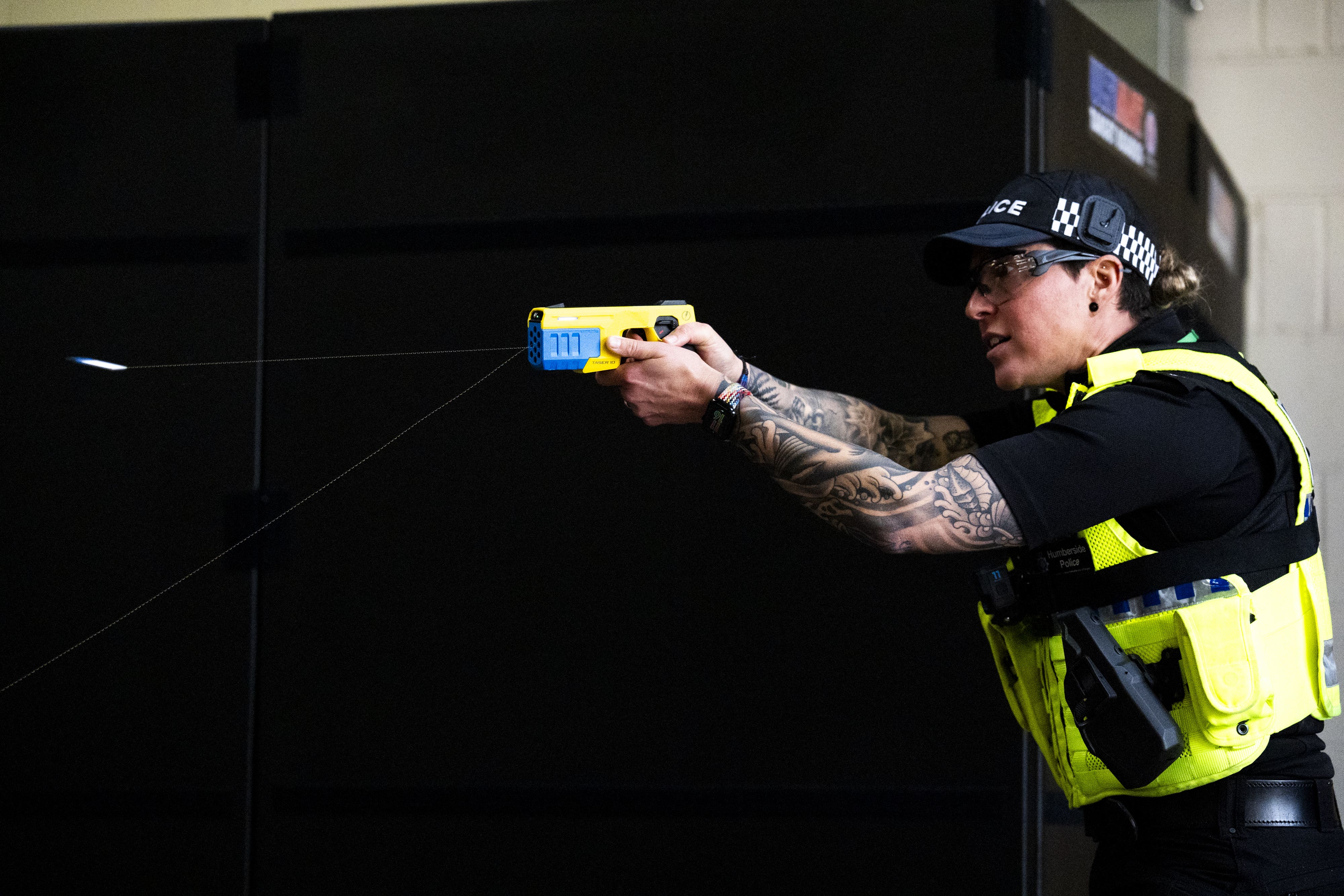 An officer discharges a probe during a demonstration of the Taser 10