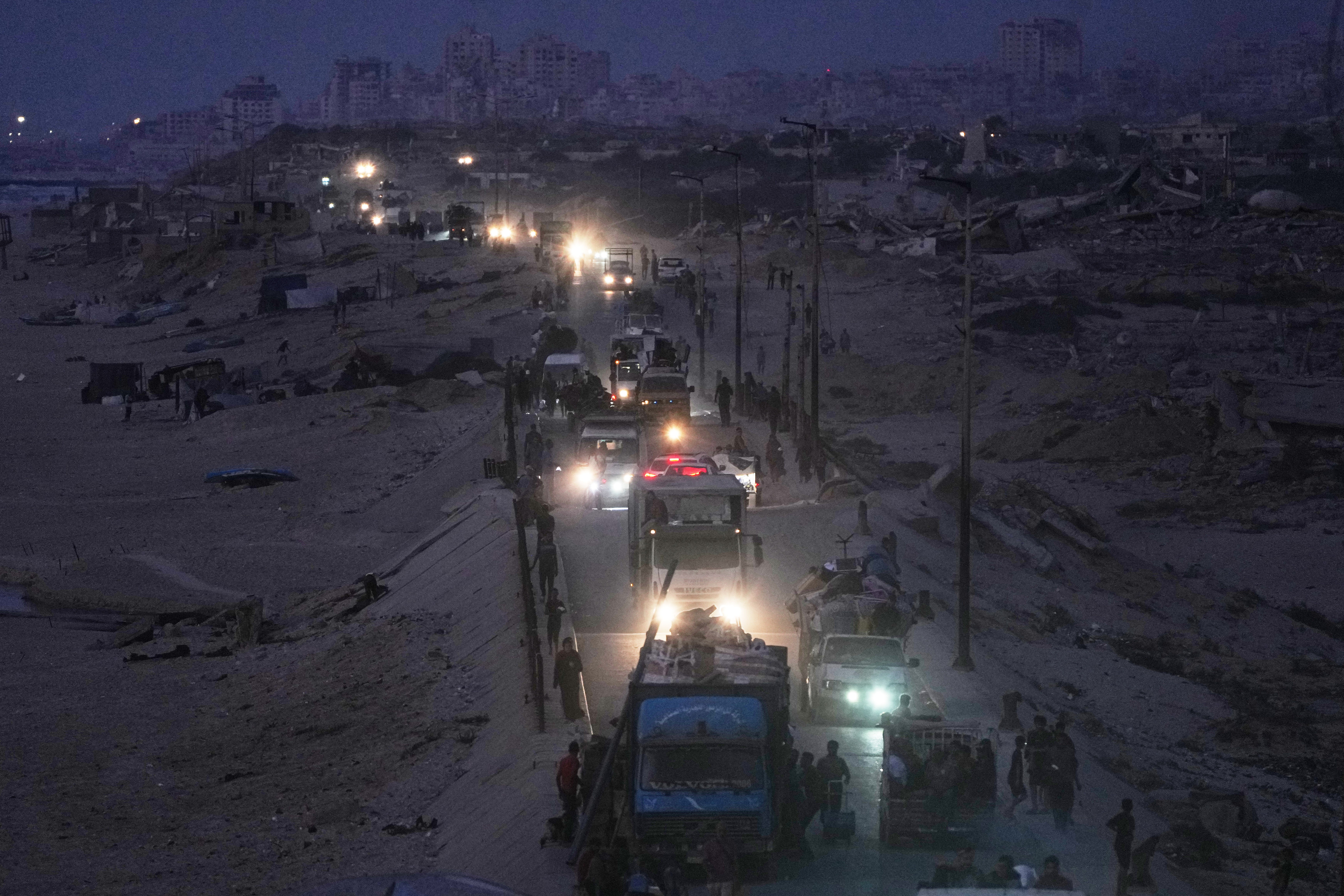 Displaced Palestinians flee northern Gaza, by vehicle and on foot, carrying their belongings along the coastal road near Wadi, last month