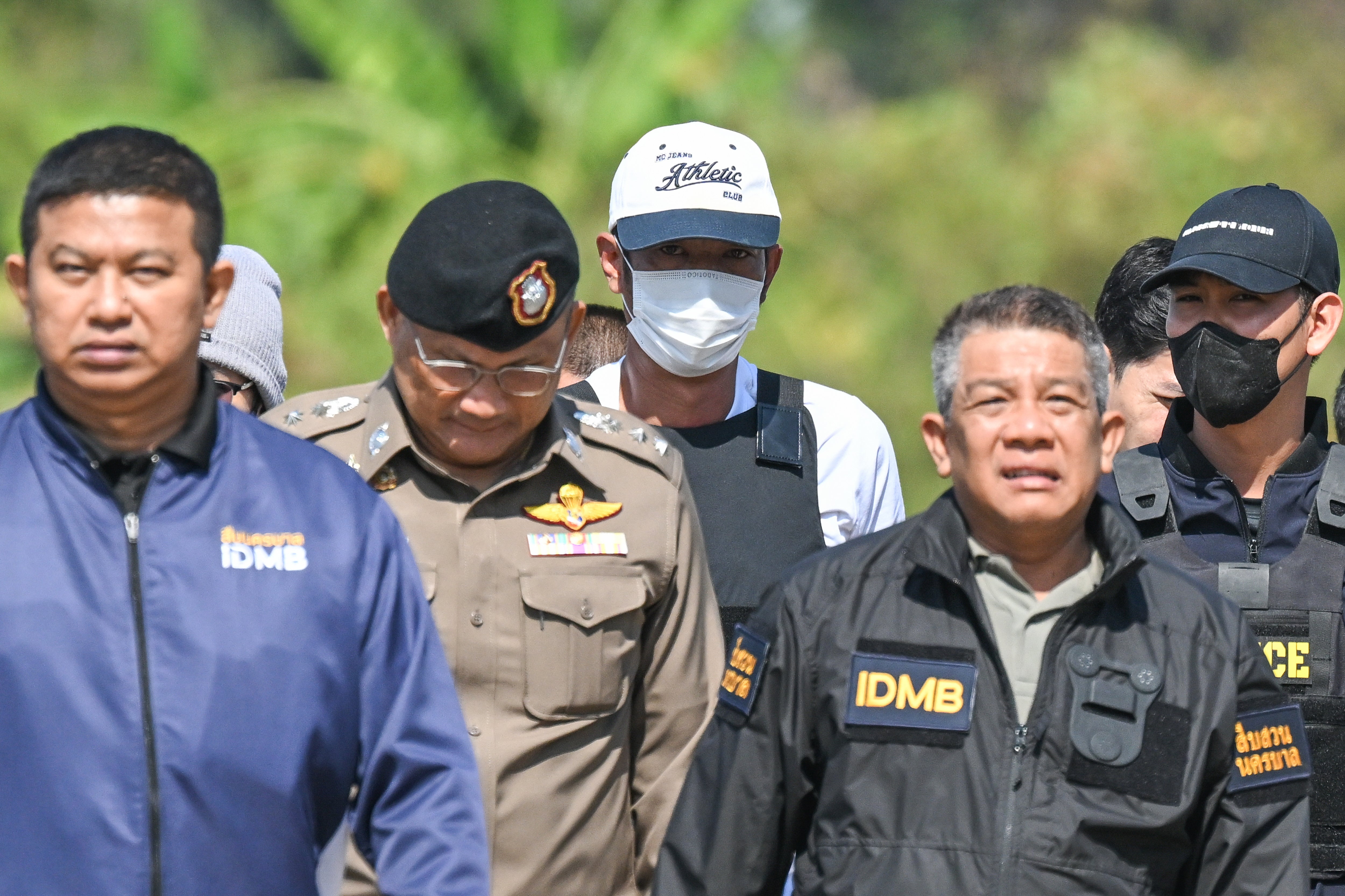 Thai police officers escort Ekkalak Pheanoi, centre, the accused in the shooting of Cambodian politician Lim Kimya, after he was deported from Cambodia, in Bangkok, Thailand, on 11 January 2025