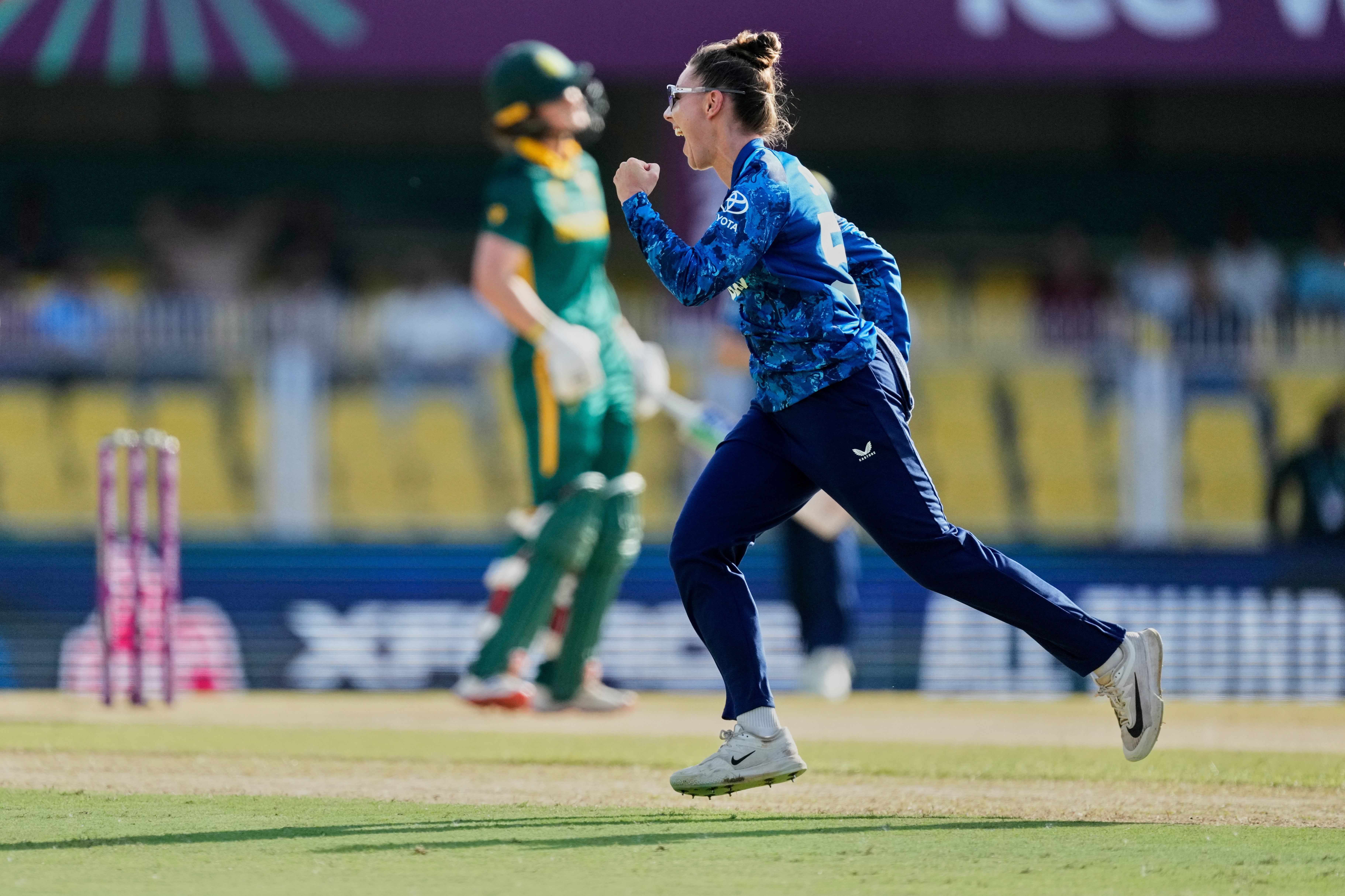 England’s Linsey Smith celebrates the dismissal of South Africa captain Laura Wolvaardt (left), during their ICC Women’s Cricket World Cup match at Barsapara Cricket Stadium in Guwahati, India, on Friday