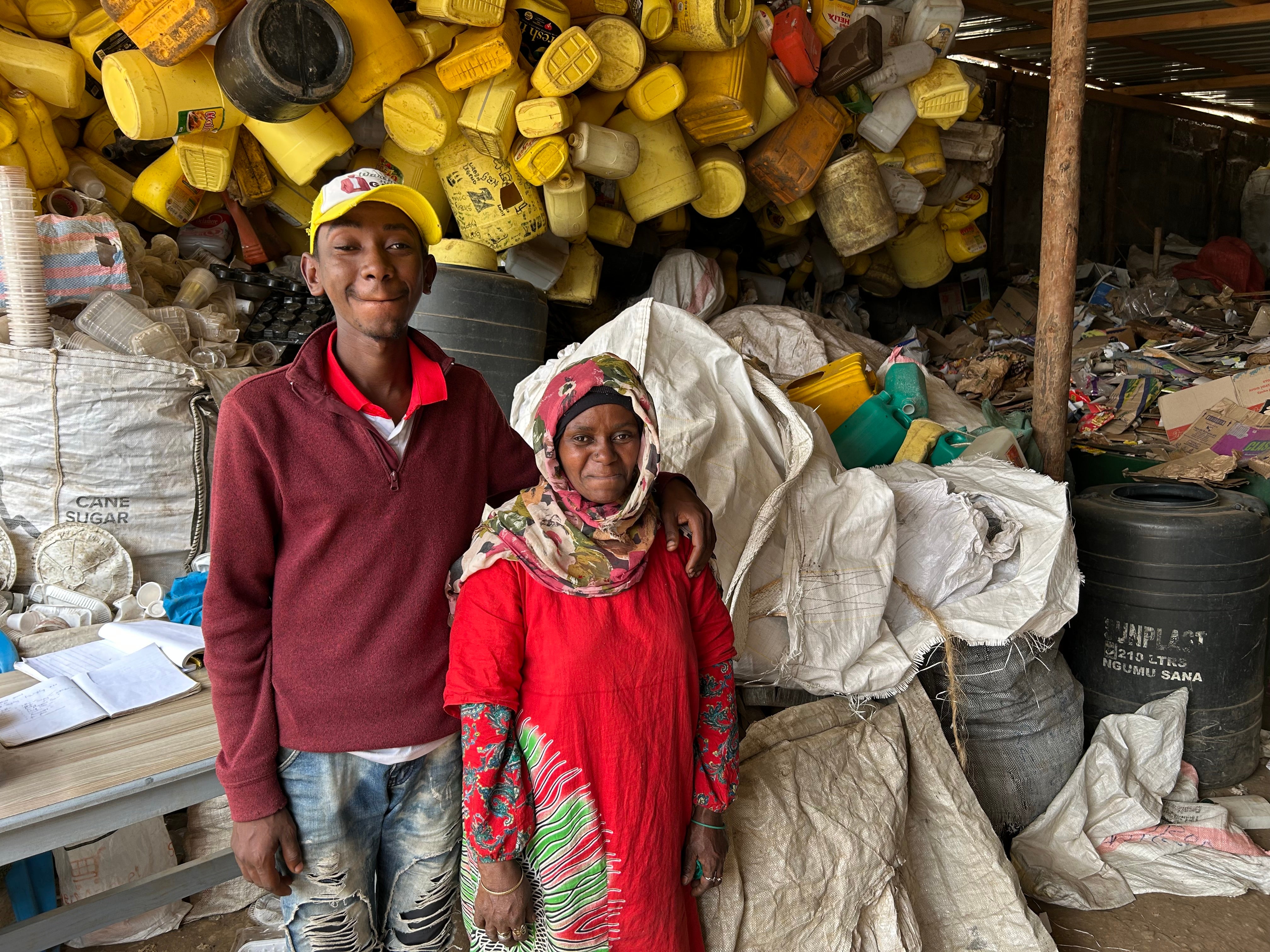 Maimuna, pictured with her son Christopher, told The Independent that both extreme heat and floods are making work on the dumpsite more difficult